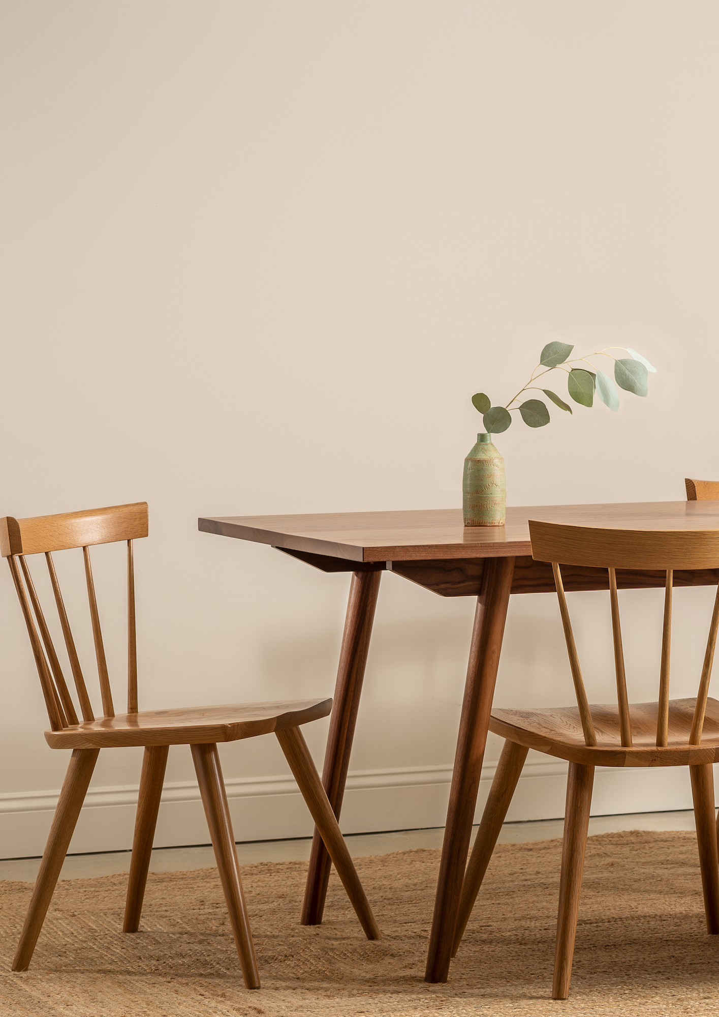 Two modern Windsor style chairs in white oak with Scandinavian inspired table and styling