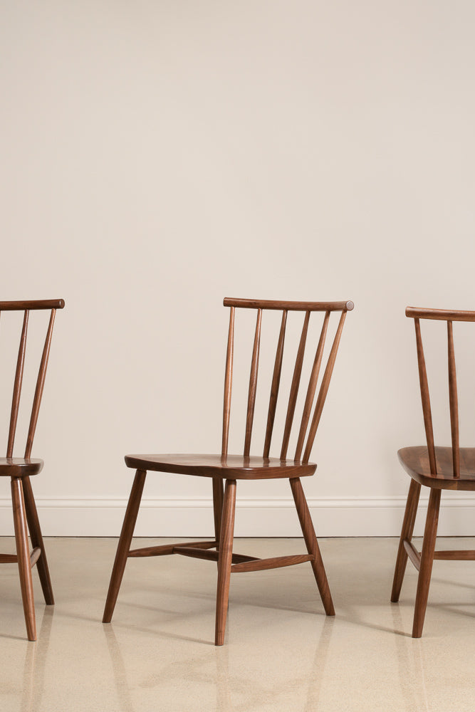 Three walnut Concord chairs lined up in a row, shown in every angle