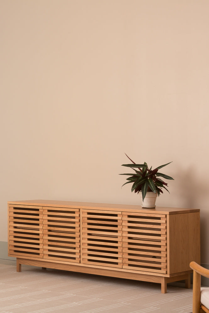 Modern minimalist living room with white oak Upland Media Stand and two Nautilis Loung Chairs for furniture, styled with plant and tan rug