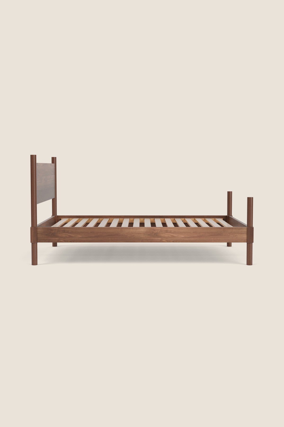 Wooden bed frame on a beige background