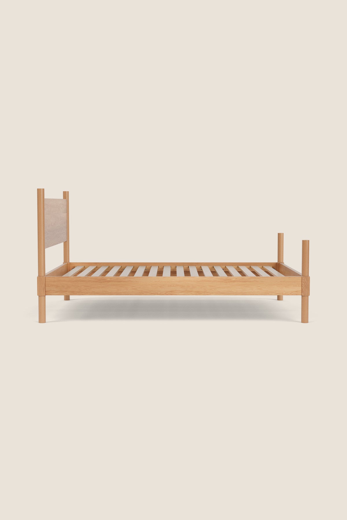 Wooden bed frame with a beige headboard on a light beige background