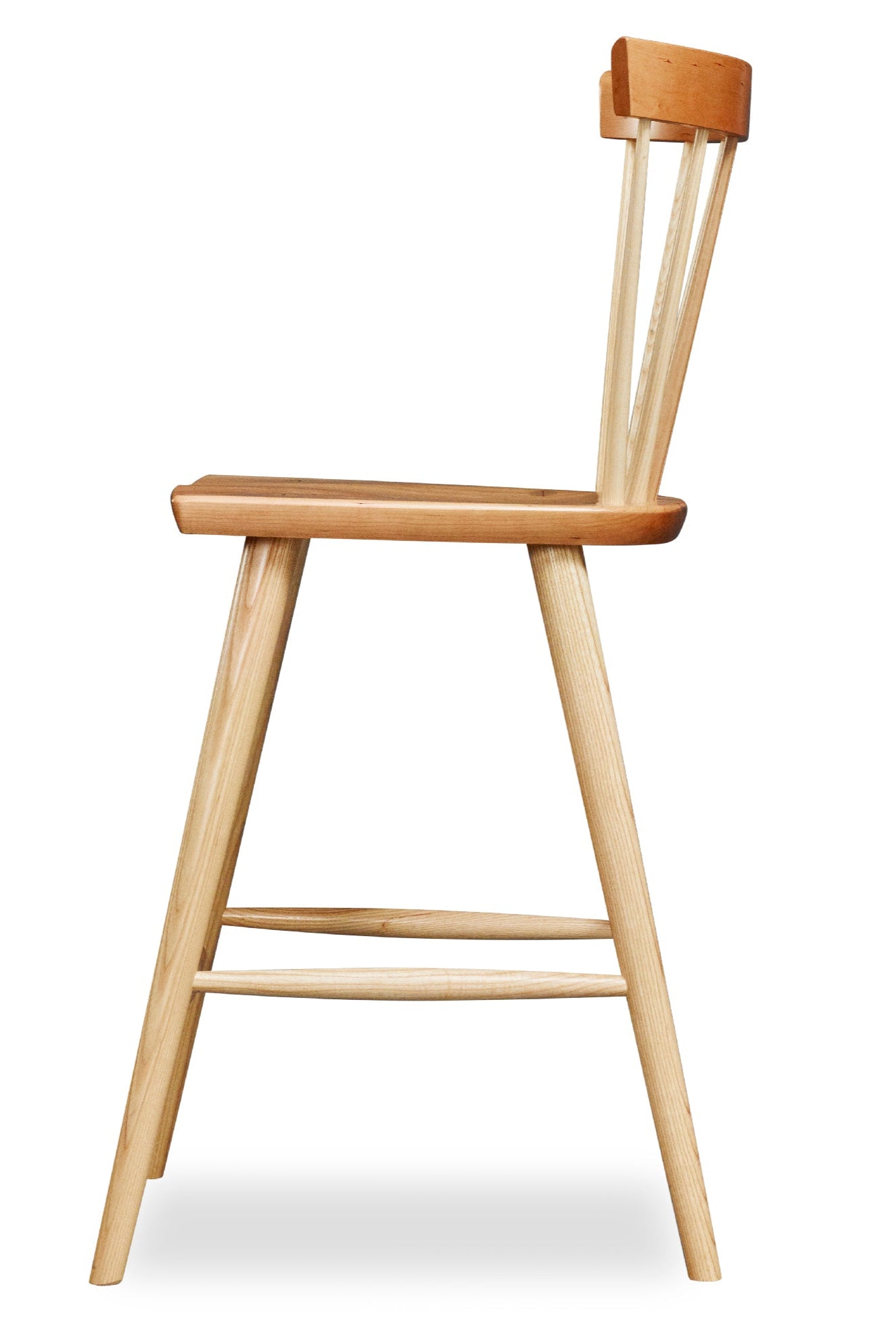 Modern Boston spindle stool with curved back in cherry and ash wood viewed from the side
