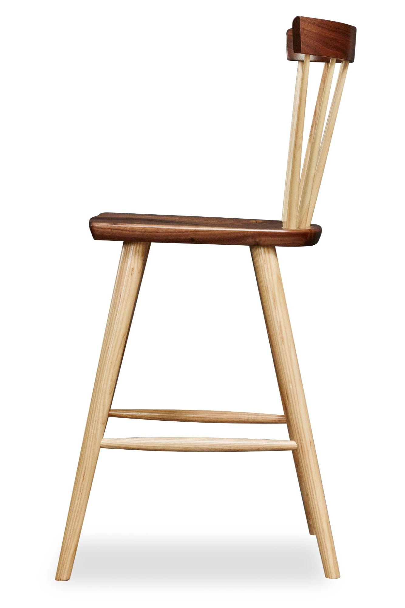 Modern Boston spindle stool with curved back in walnut and ash wood viewed from the side