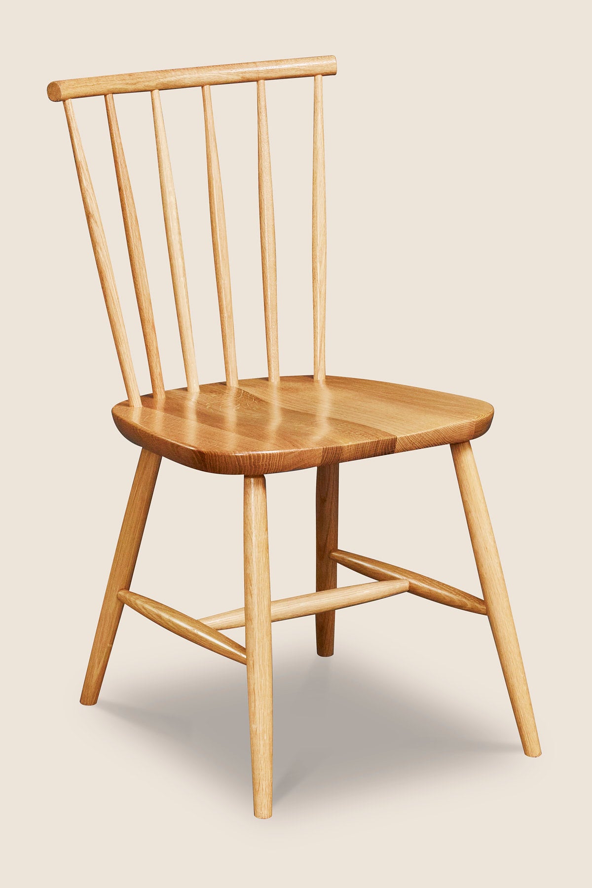 Windsor style chair with round crest in oak