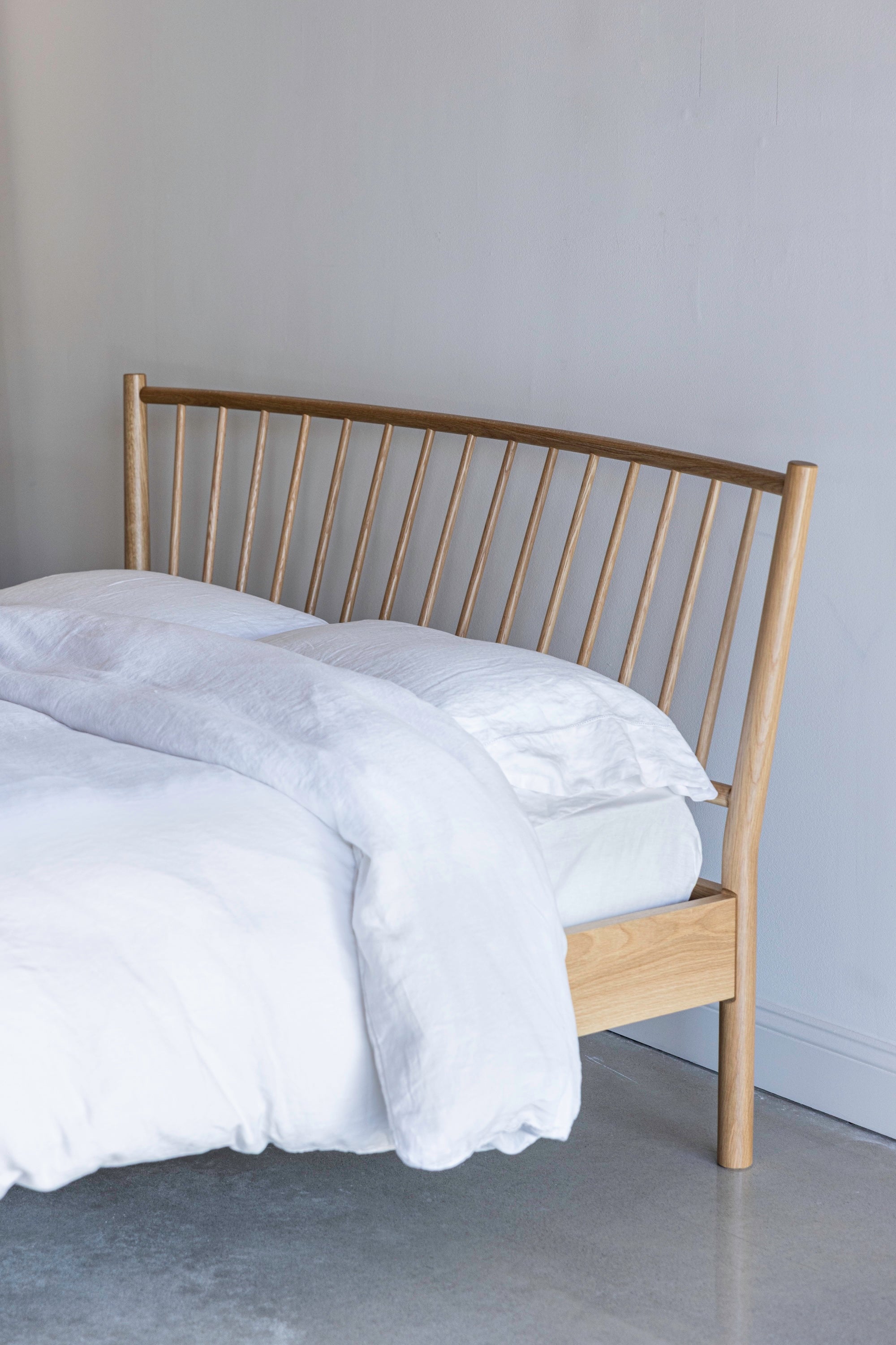 Chamberlain Bed from Chilton Furniture in Maine with a curved spindle headboard and white bedding