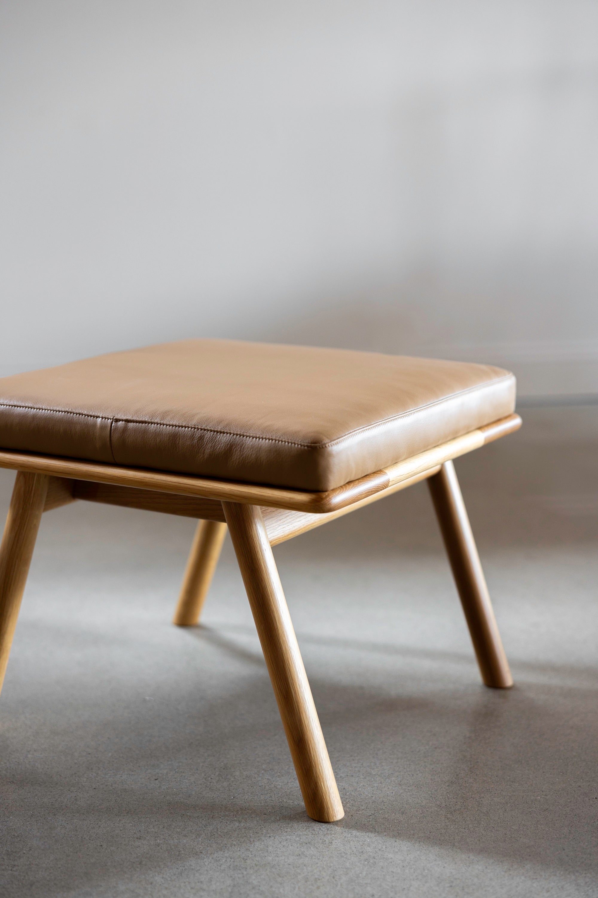 Solid white oak wood Scandinavian style Nautilus Ottoman with leather cushions from Maine's Chilton Furniture Co.