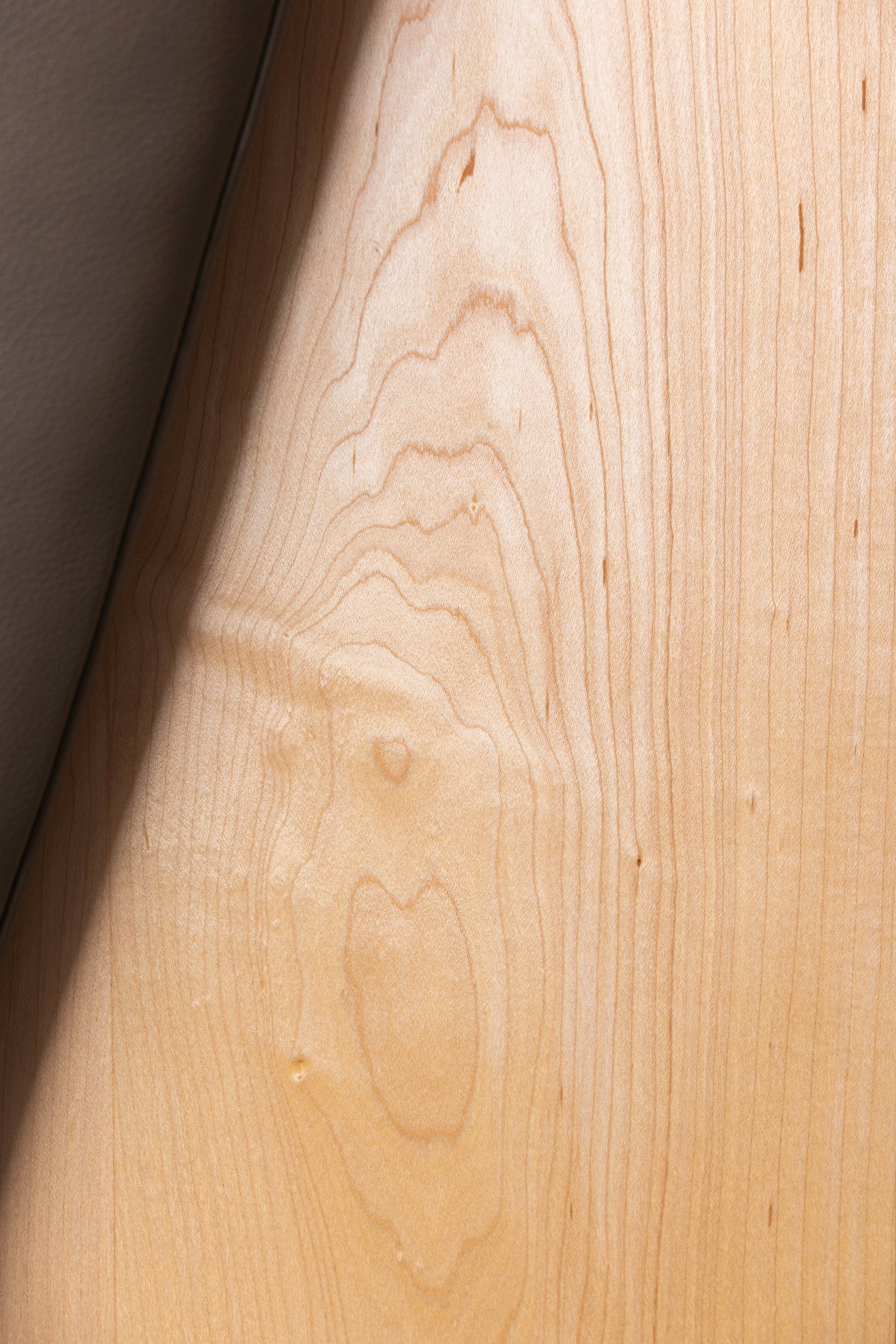 Leather cushion against the beautiful solid maple grain of the Hudson Bench from Chilton Furniture in Maine