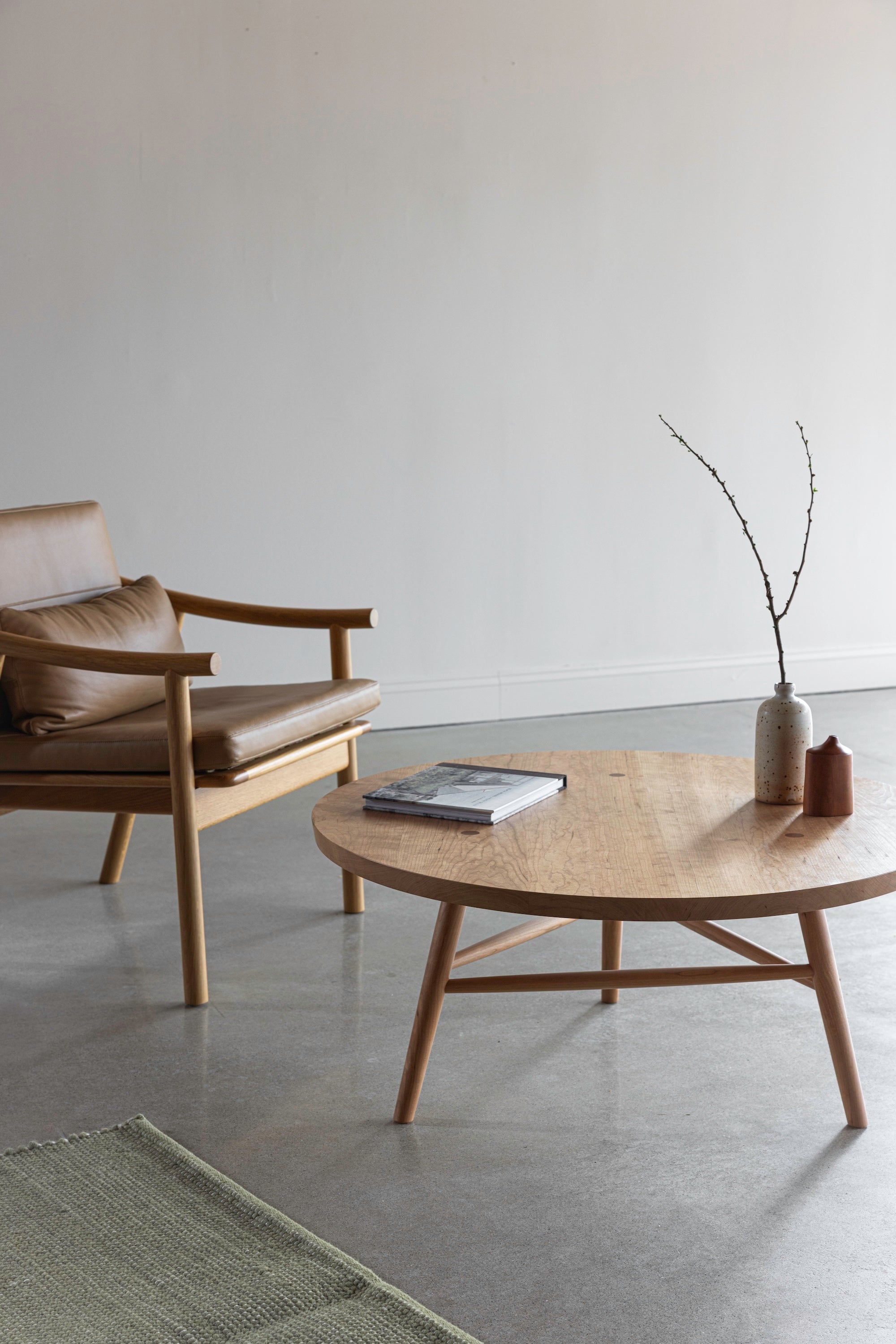 Solid wood Nautilus lounge chair with leather cushions next to Hudson Coffee Table from Maine's Chilton Furniture Co.