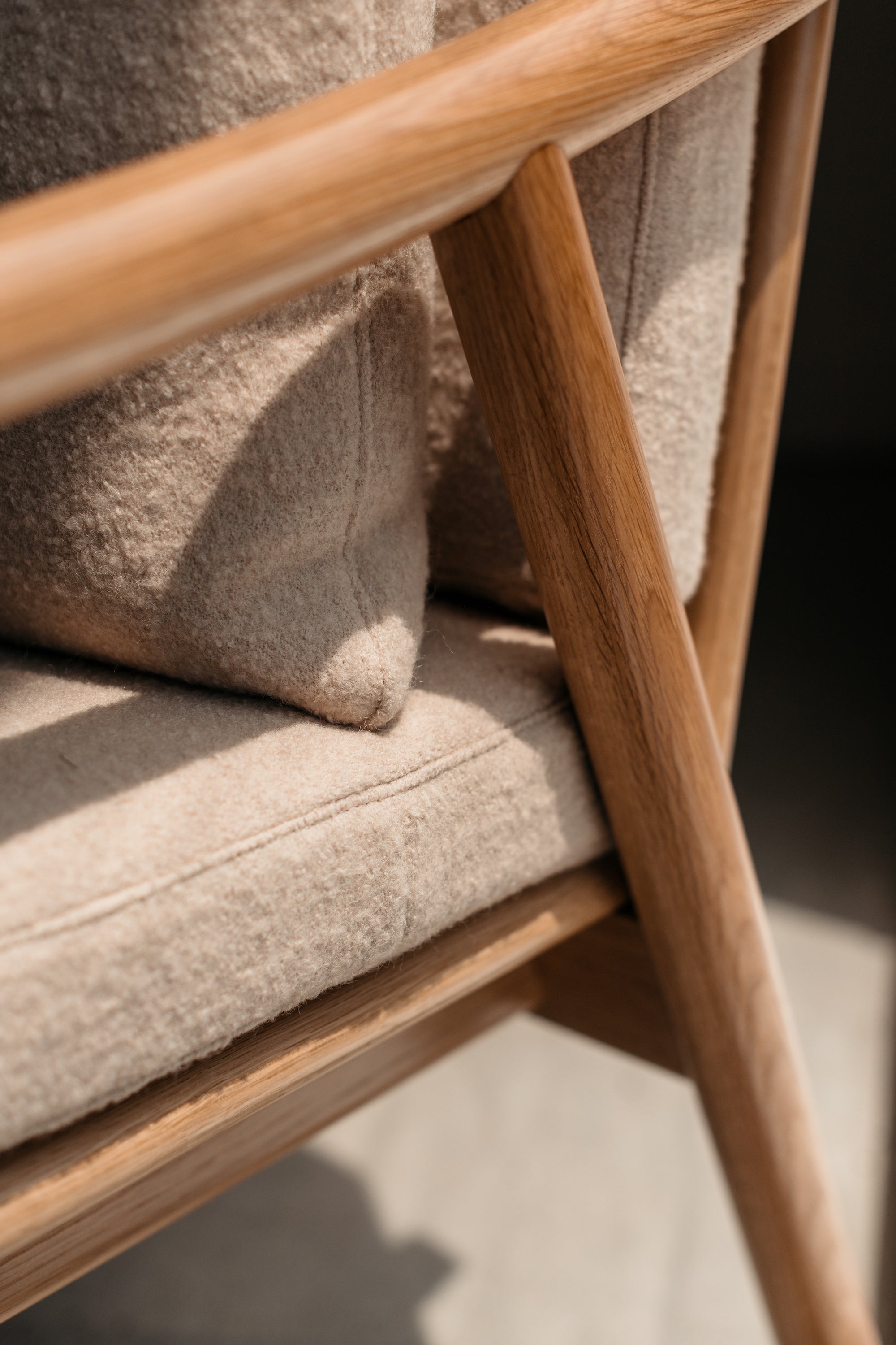 Joinery on arms of Nautilus Lounge Chair with boucle fabric cushions