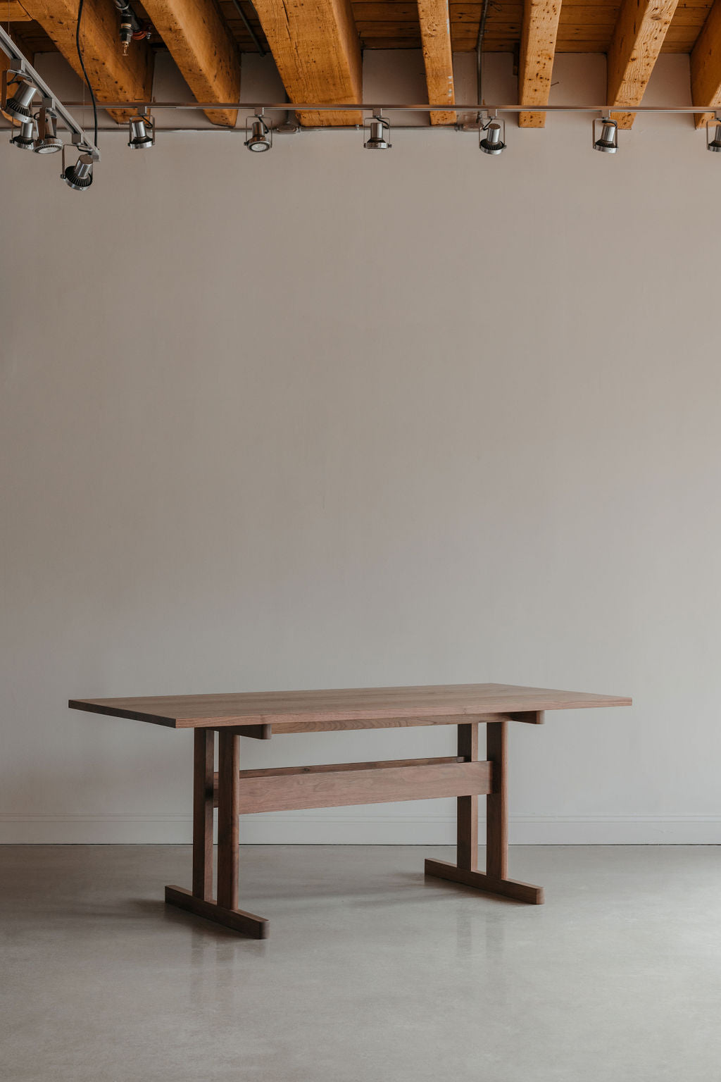 Knox Dining Table in industrial room with wooden beams