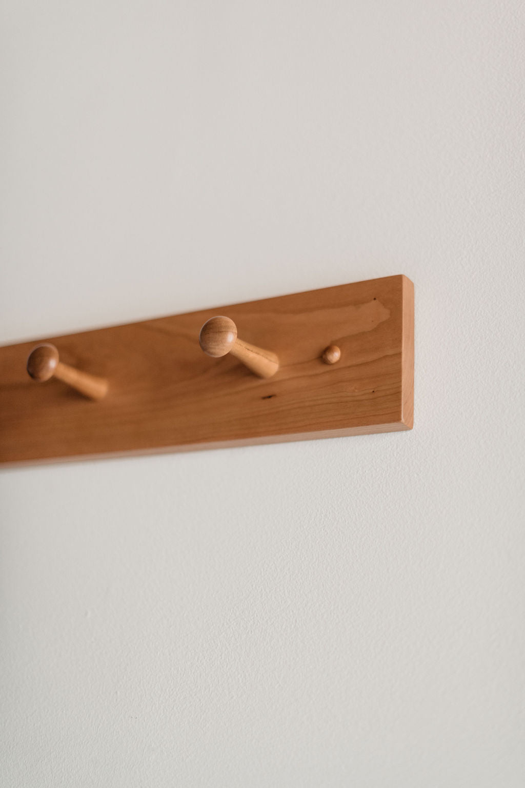 Details of the pegs and screw caps on the peg rack from Chilton Furniture