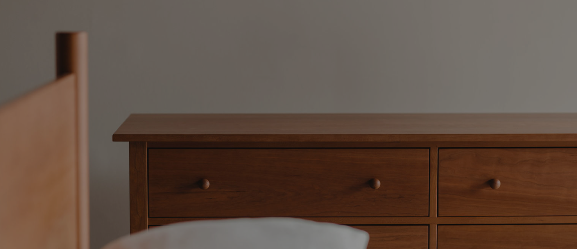 Wooden dresser against a plain wall