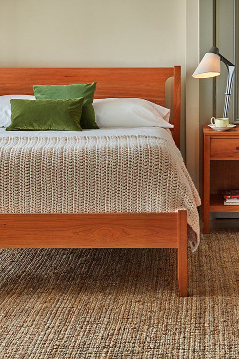 Bedroom with Shaker style solid cherry wood bed with Scandinavian style dresser and nightstand from Maine's Chilton Furniture Co.