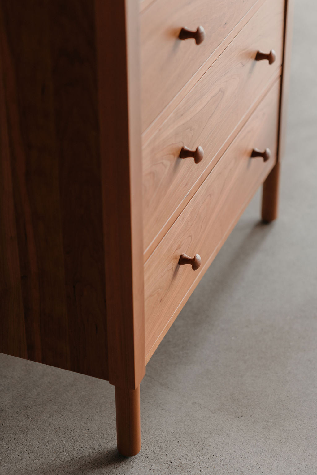 Wooden dresser with a focus on the lower part of the cabinet with rounded legs