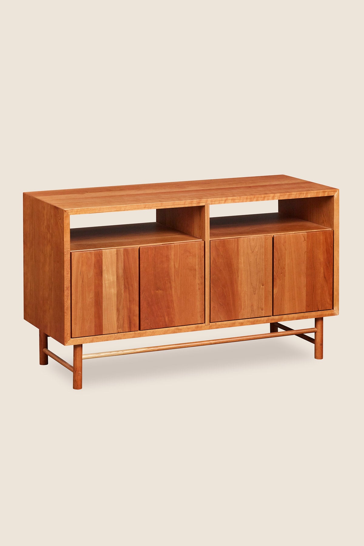 Mid-century modern Navarend media case in solid cherry wood with round legs and stretchers and four doors with storage space