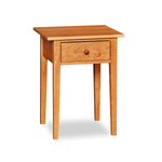 Modern interpretation of a classic Shaker style nightstand with one drawer and square tapered legs, in solid cherry wood
