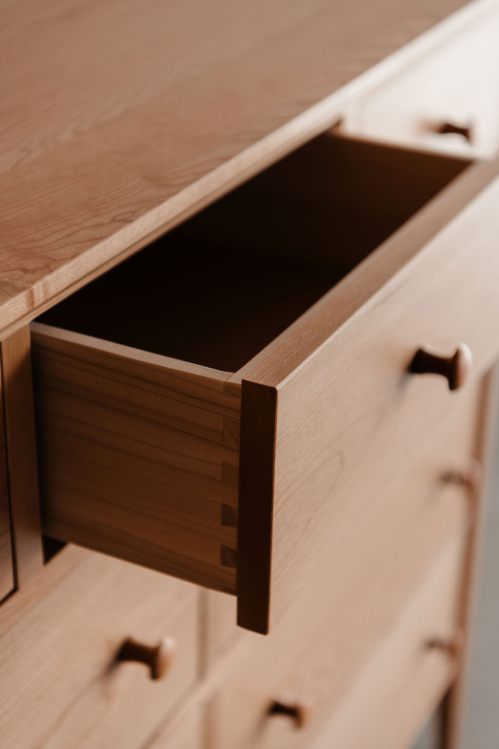 Wooden dresser with open drawer to show knob and joinery details