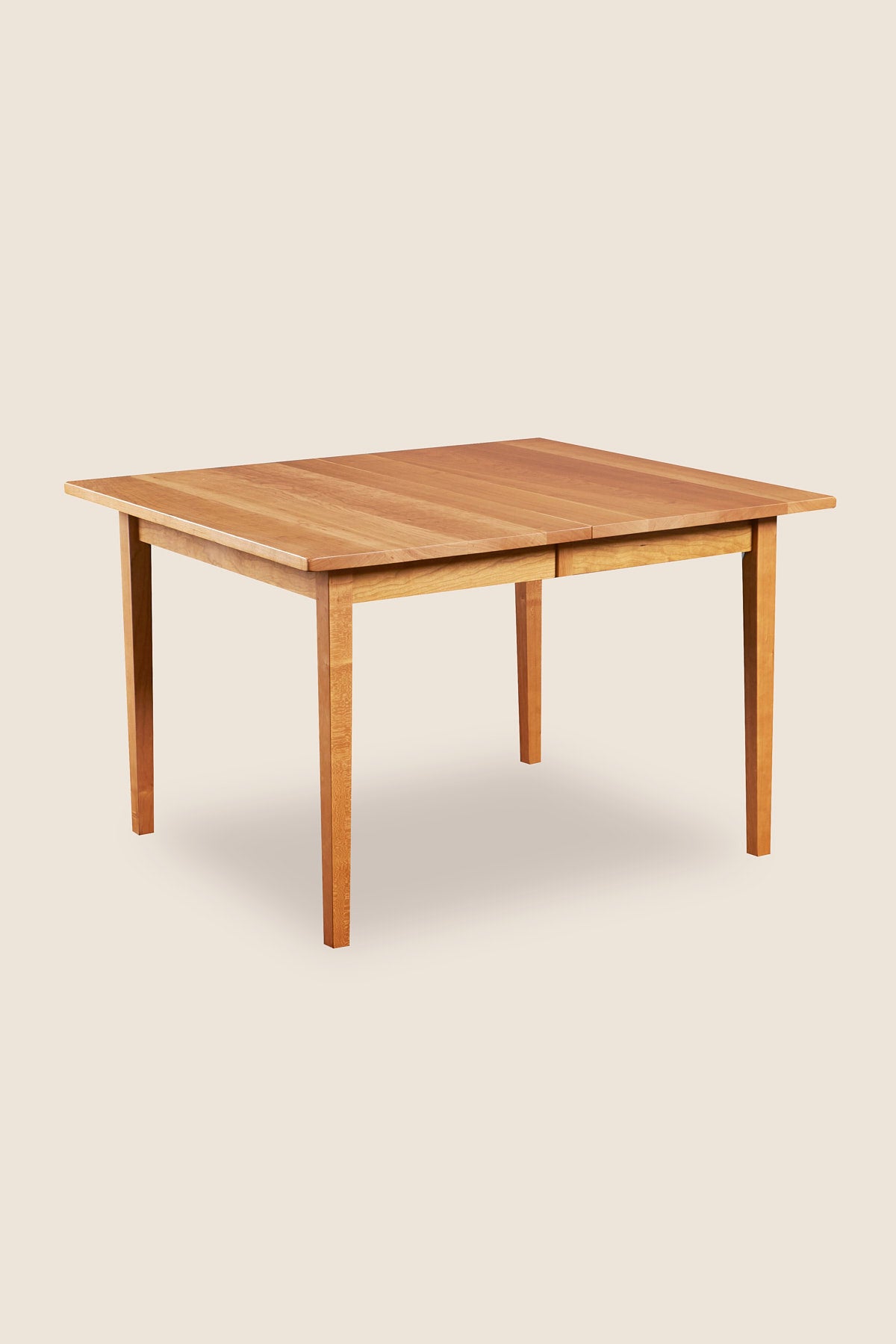 Solid cherry wood extension table with tapered Shaker legs from Maine's Chilton Furniture Co.