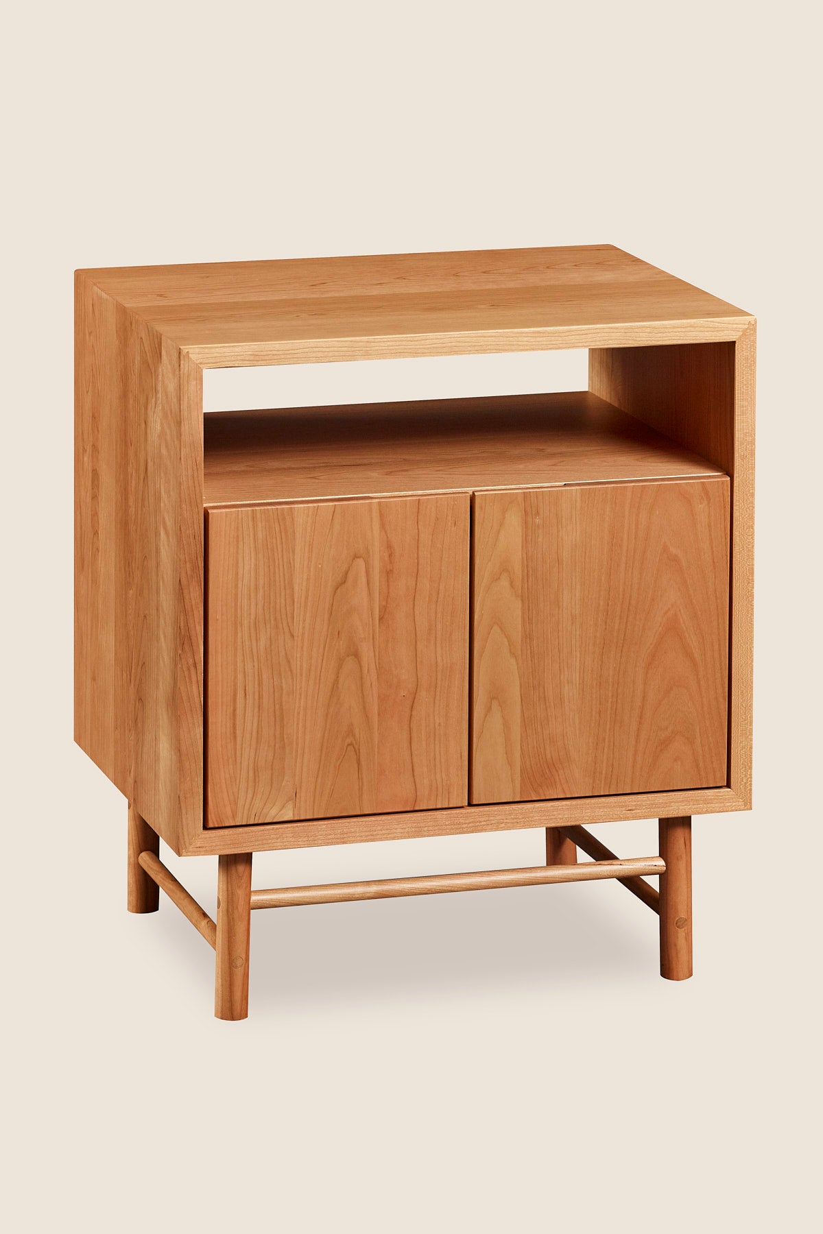 Mid-century modern Navarend media case in solid cherry wood with round legs and stretchers and two doors with storage space