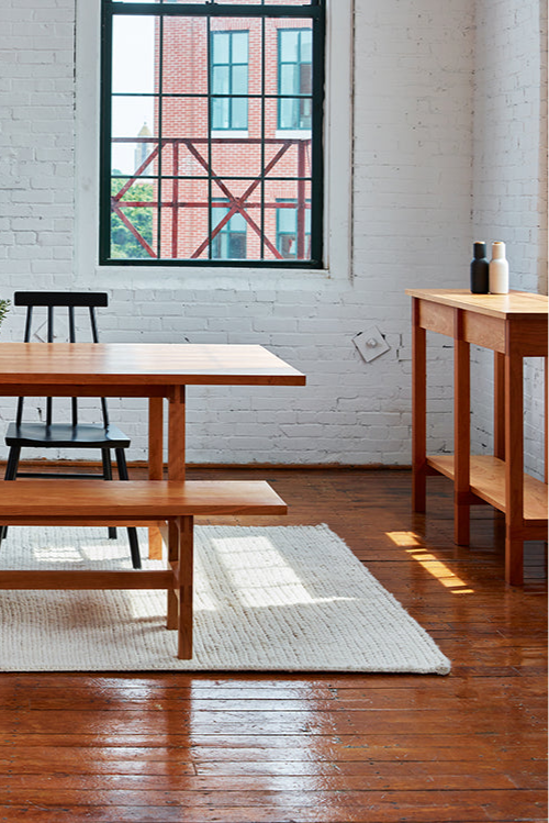 Warehouse loft dining room furnished with modern Union Sideboard, Table and Bench from Maine's Chilton Furniture Co.