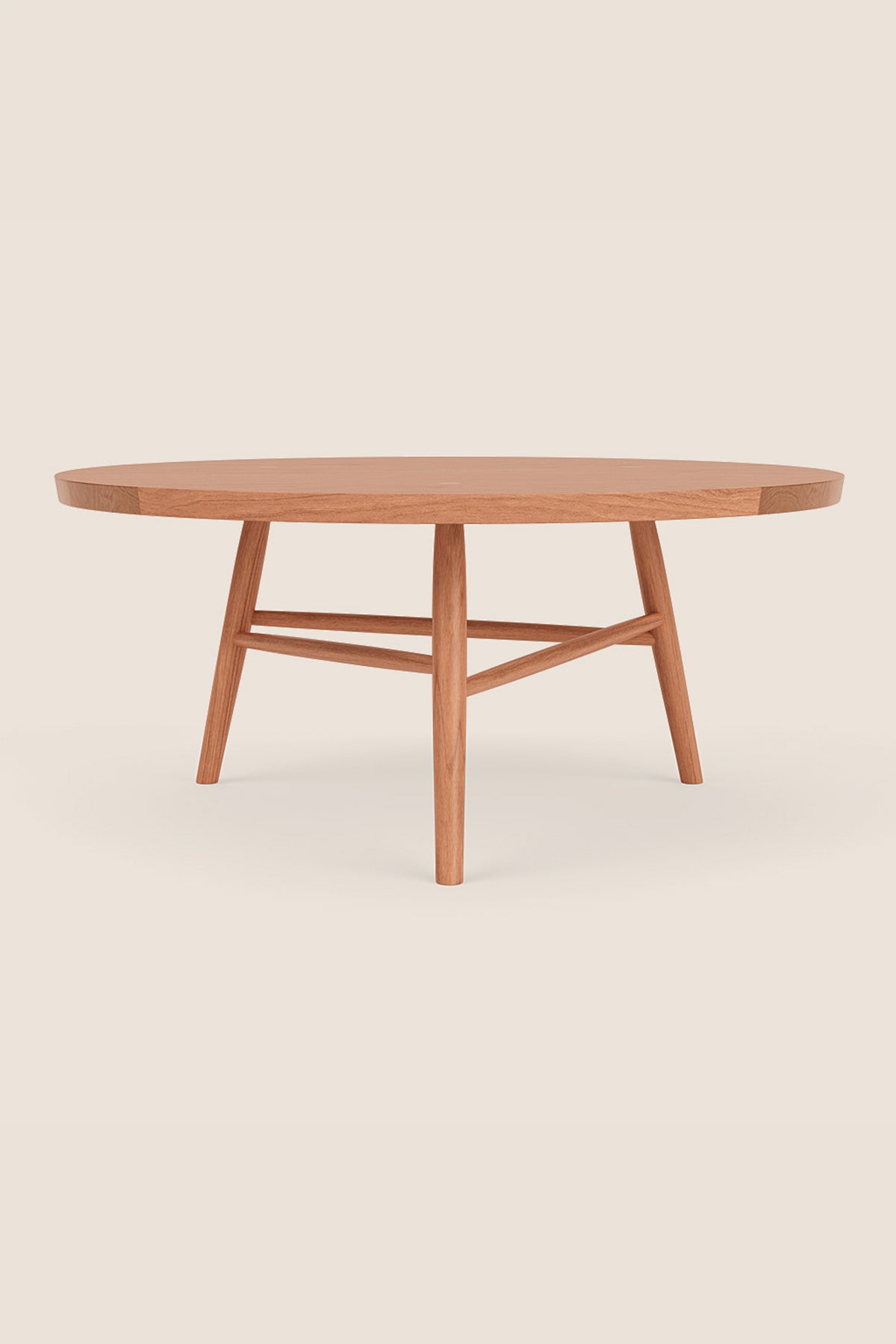 Round wooden Hudson Coffee Table in cherry with three legs on beige background