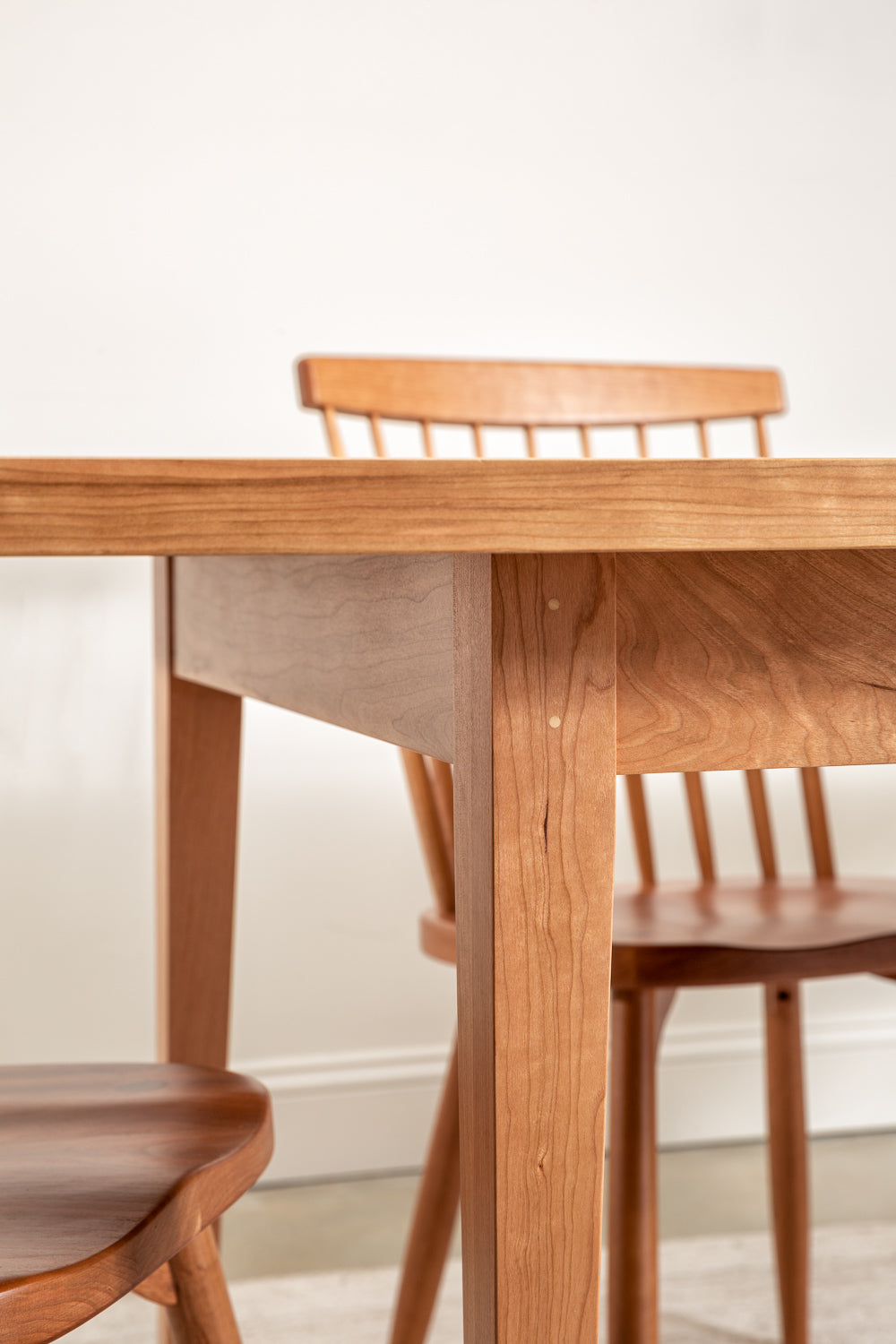 Solid wood Shaker dining table with spindle chairs.