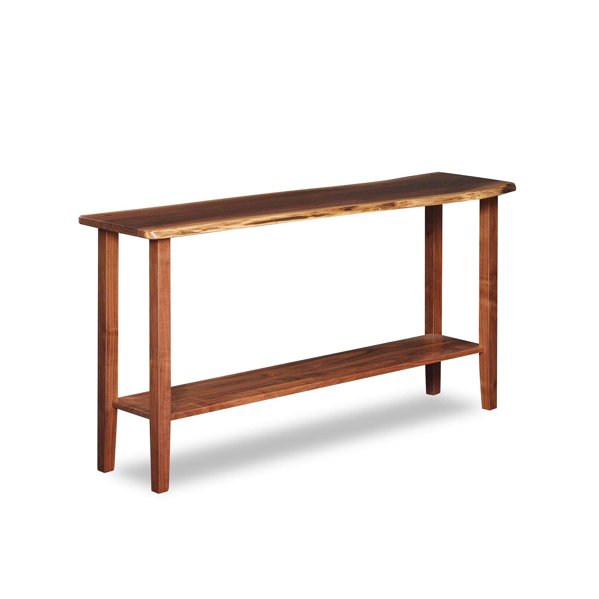 Live edge solid walnut sofa table with four post legs and low shelf, from Maine's Chilton Furniture Co.