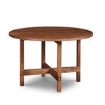 Modern round trestle table with visible joinery in walnut, from Maine's Chilton Furniture Co.