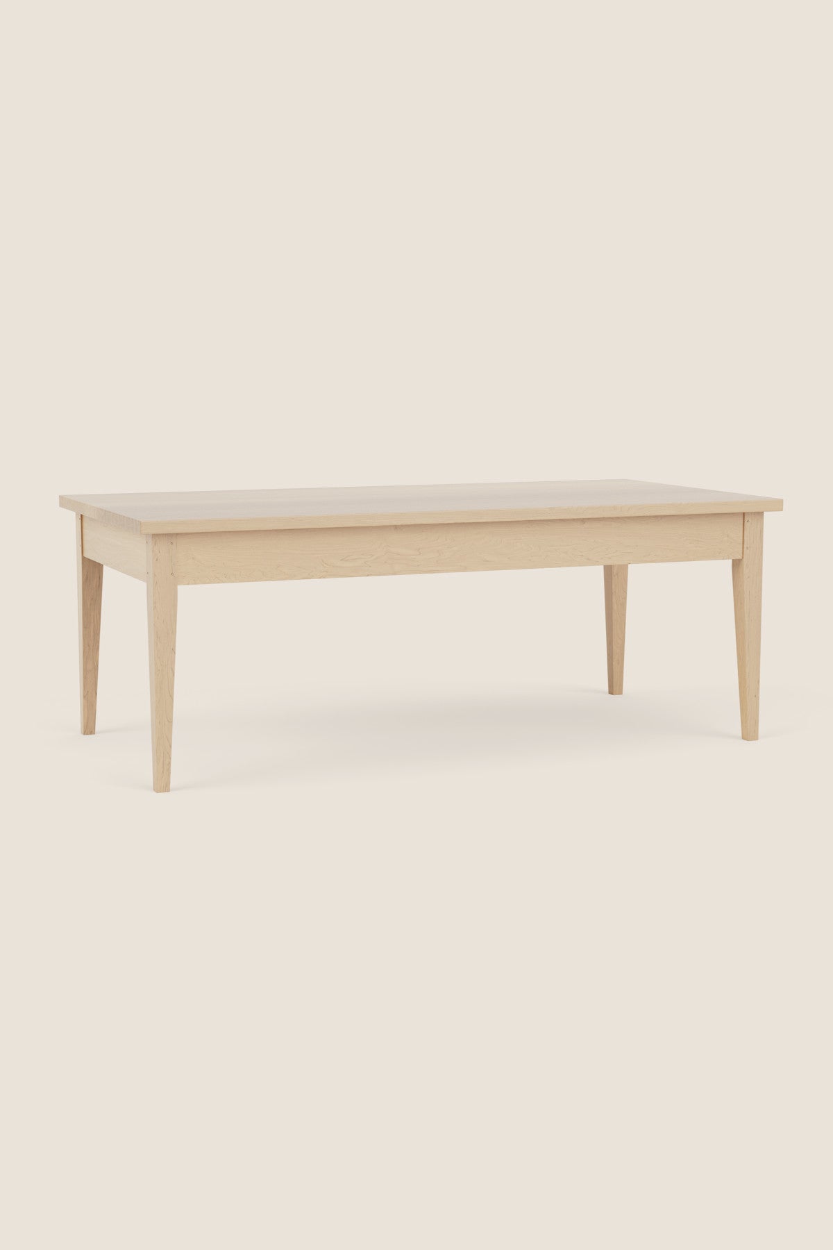 Simple Shaker style coffee table in maple on beige background