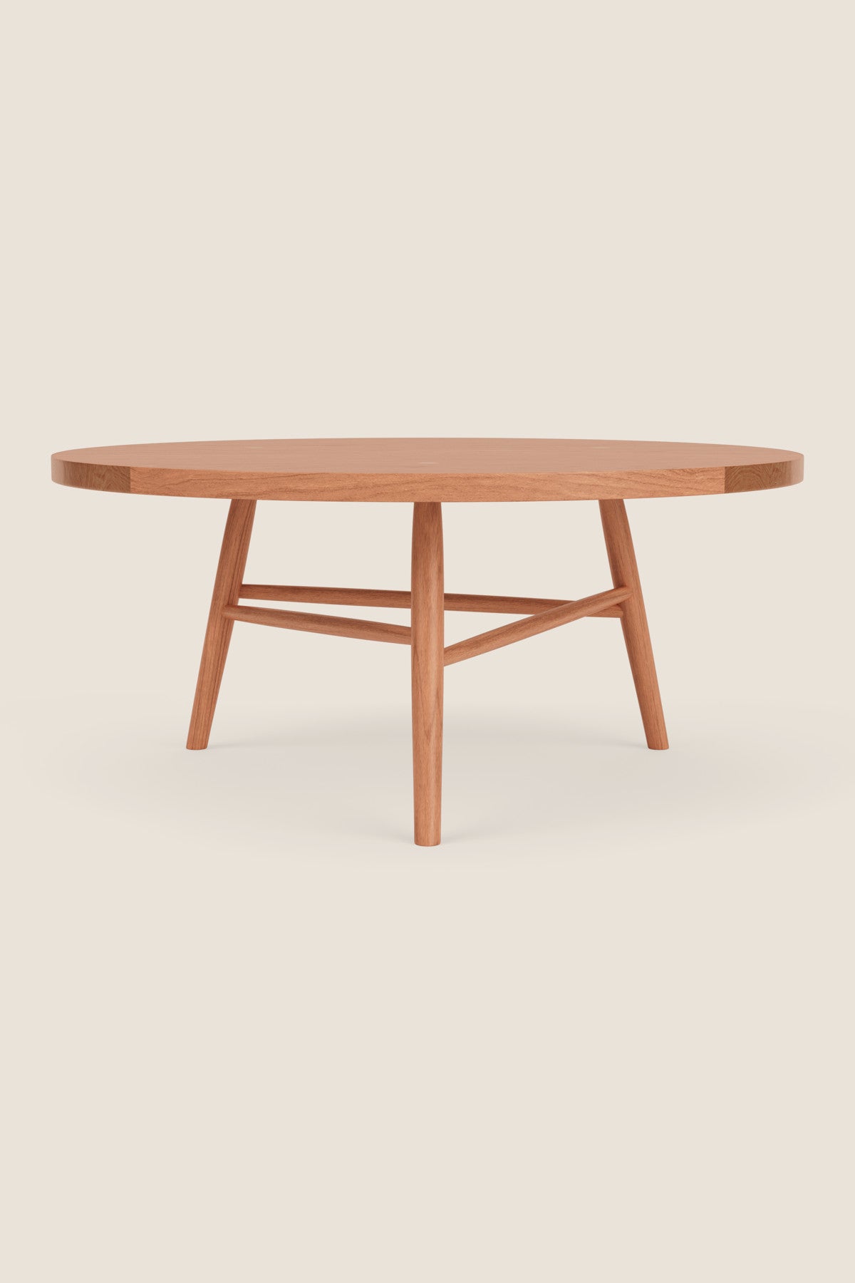 Round wooden Hudson Coffee Table with three legs on beige background