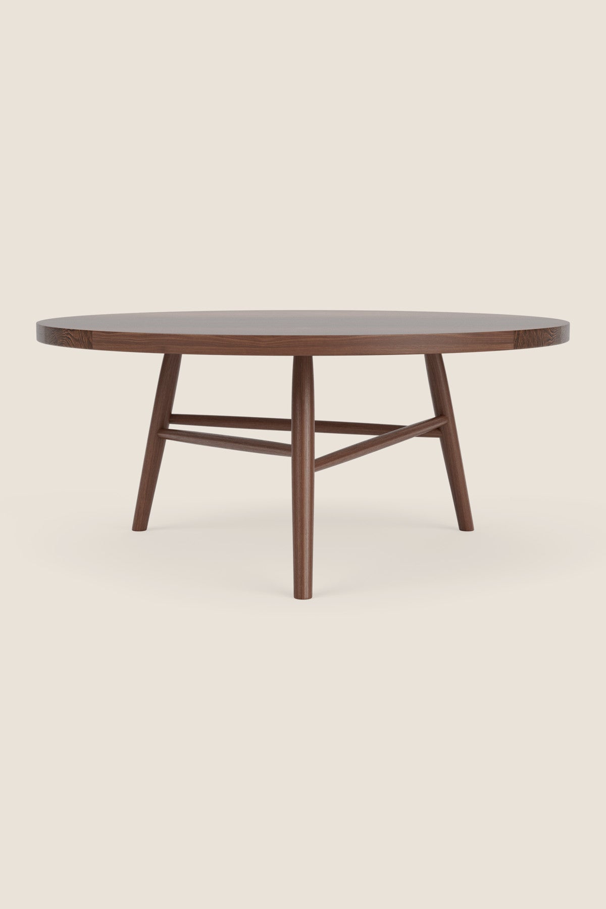 Round wooden Hudson Coffee Table with three legs on beige background