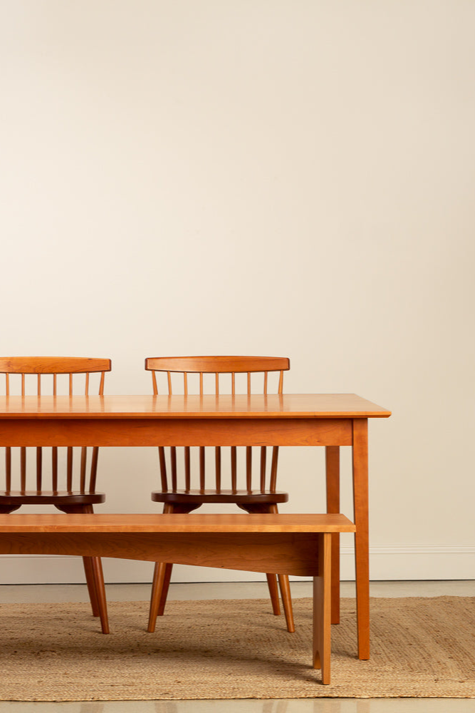 Mazhil & Co.'s Shaker Dining Table paired with the Shaker Bench and Chilton Spindle Chairs in solid cherry wood