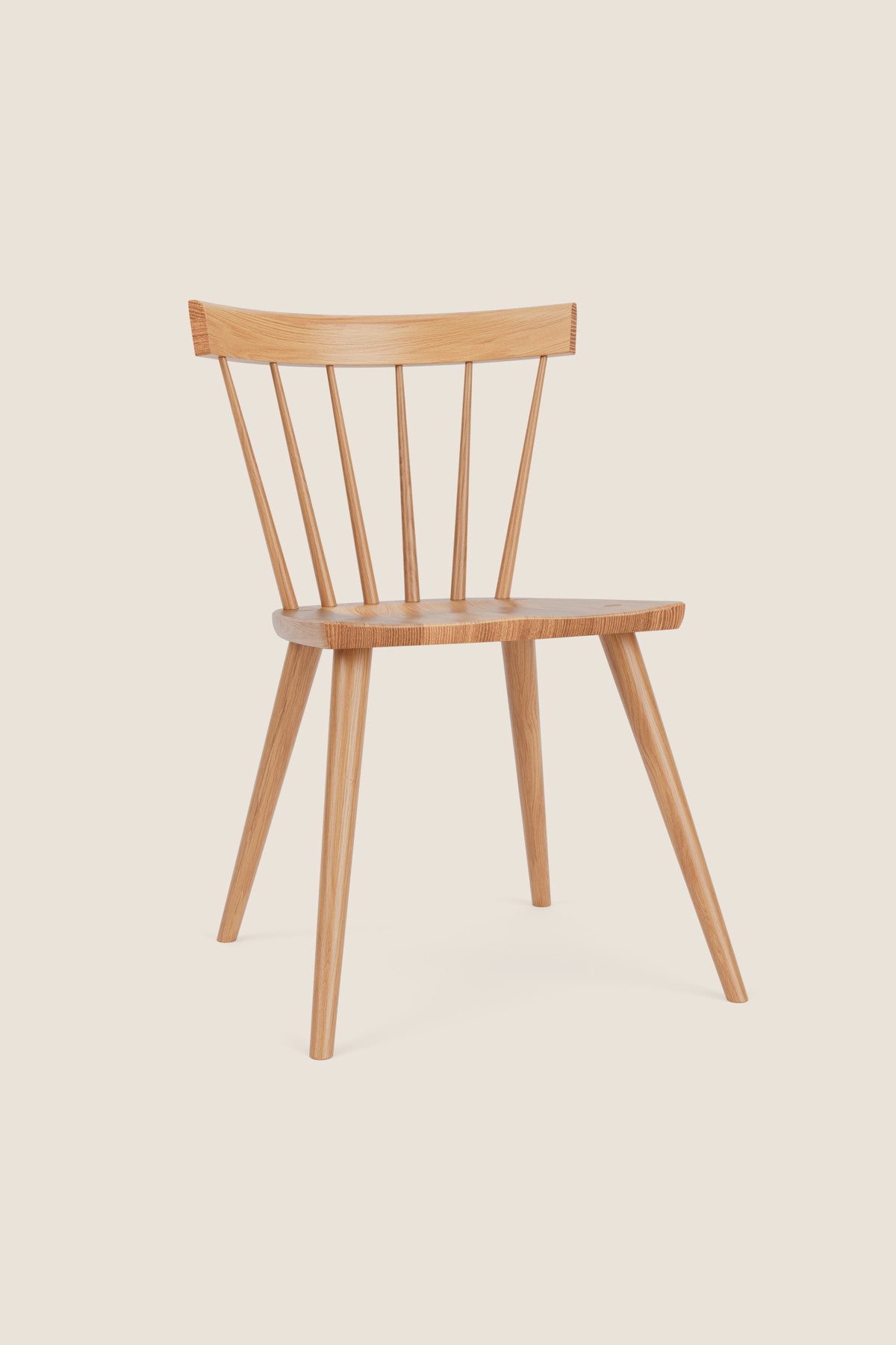 Modern Windsor inspired spindle chair with curved back in white oak