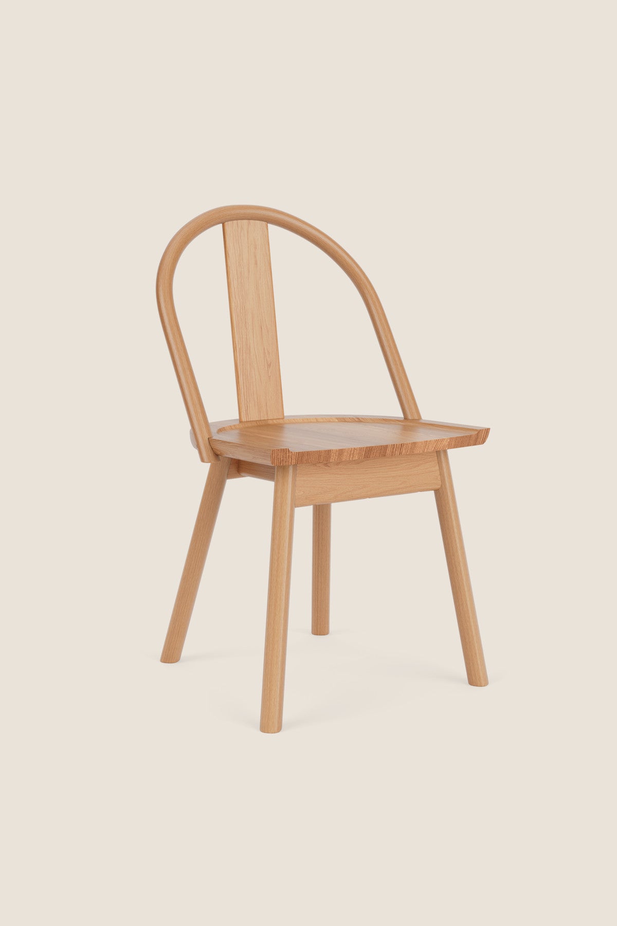 A modern version of a traditional bowback chair in white oak wood