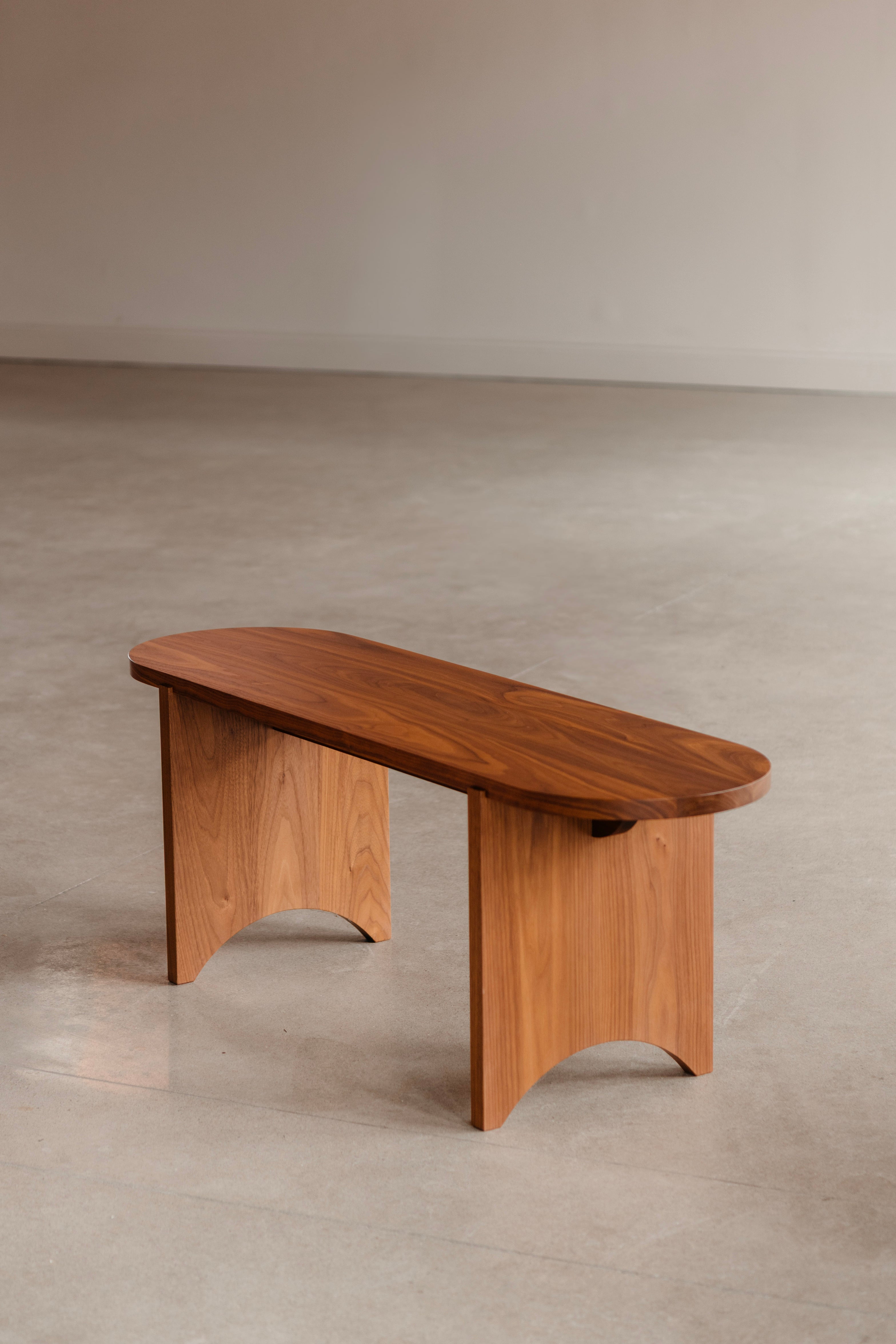 Modern Shaker walnut bench with rounded edges and legs from Chilton Furniture in Maine. In minimalist setting.