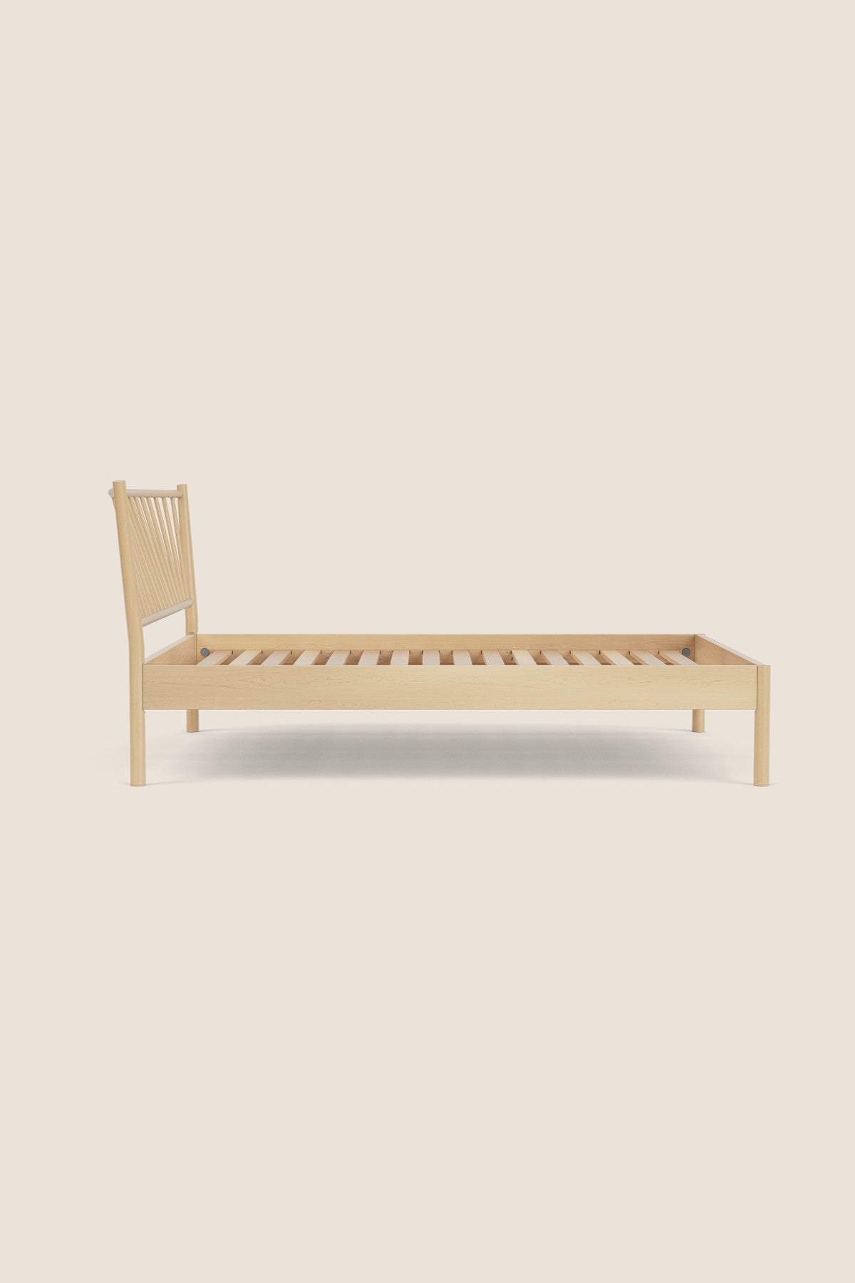 Wooden bed frame on a beige background