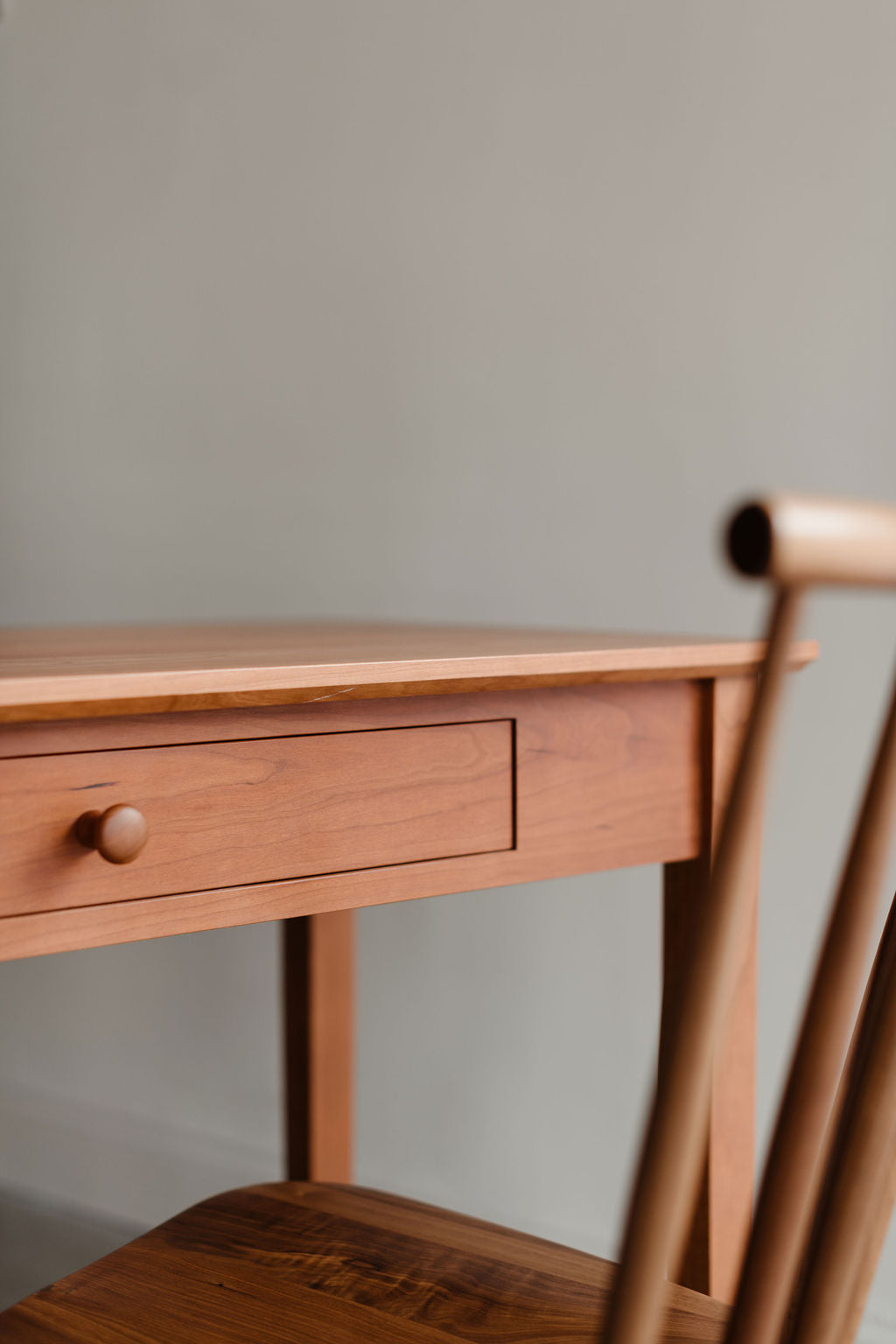 Wooden Shaker desk from Chilton Furntiure with a chair against a plain wall