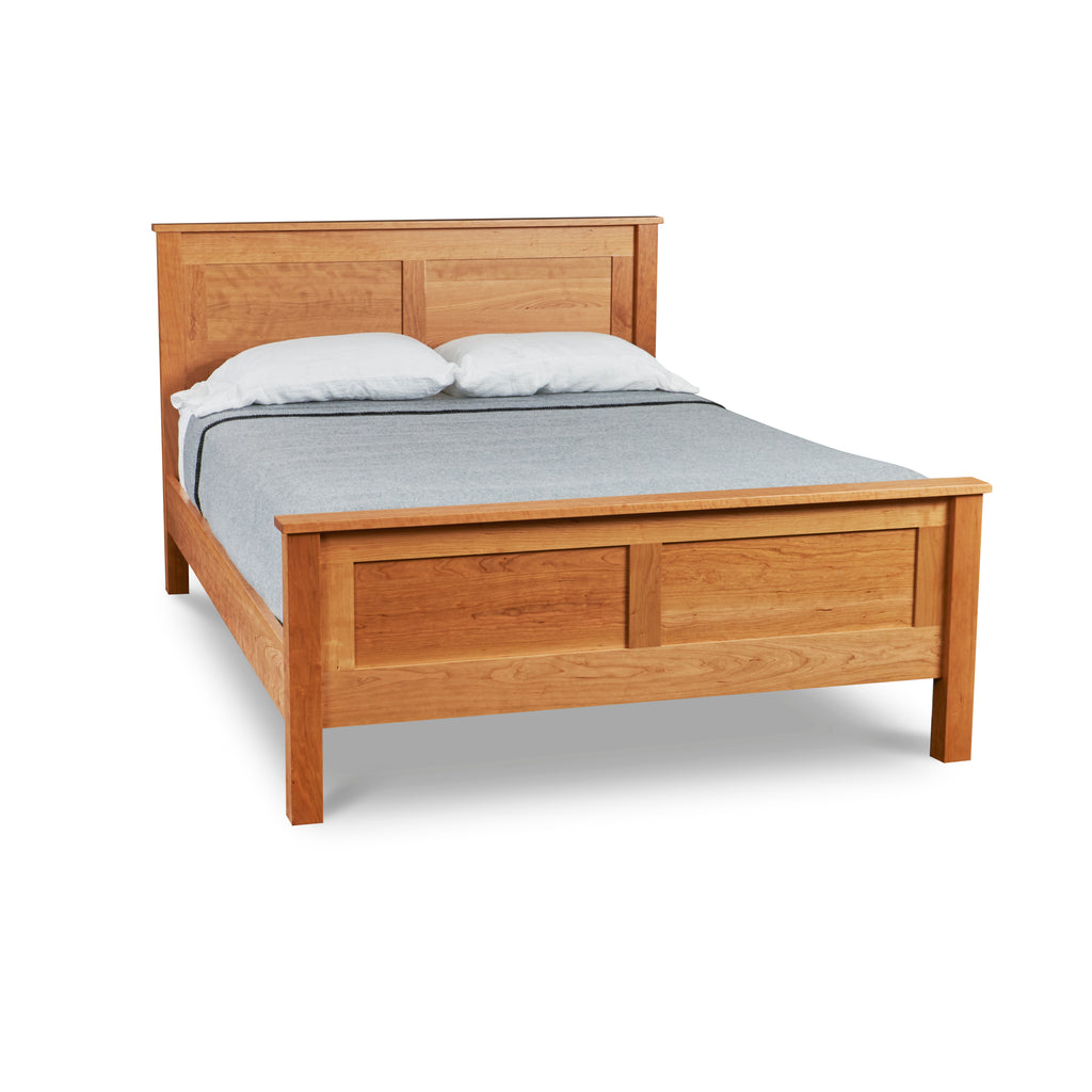 Traditional style bed with high headboard and footboard in cherry wood from Chilton Furniture of Maine