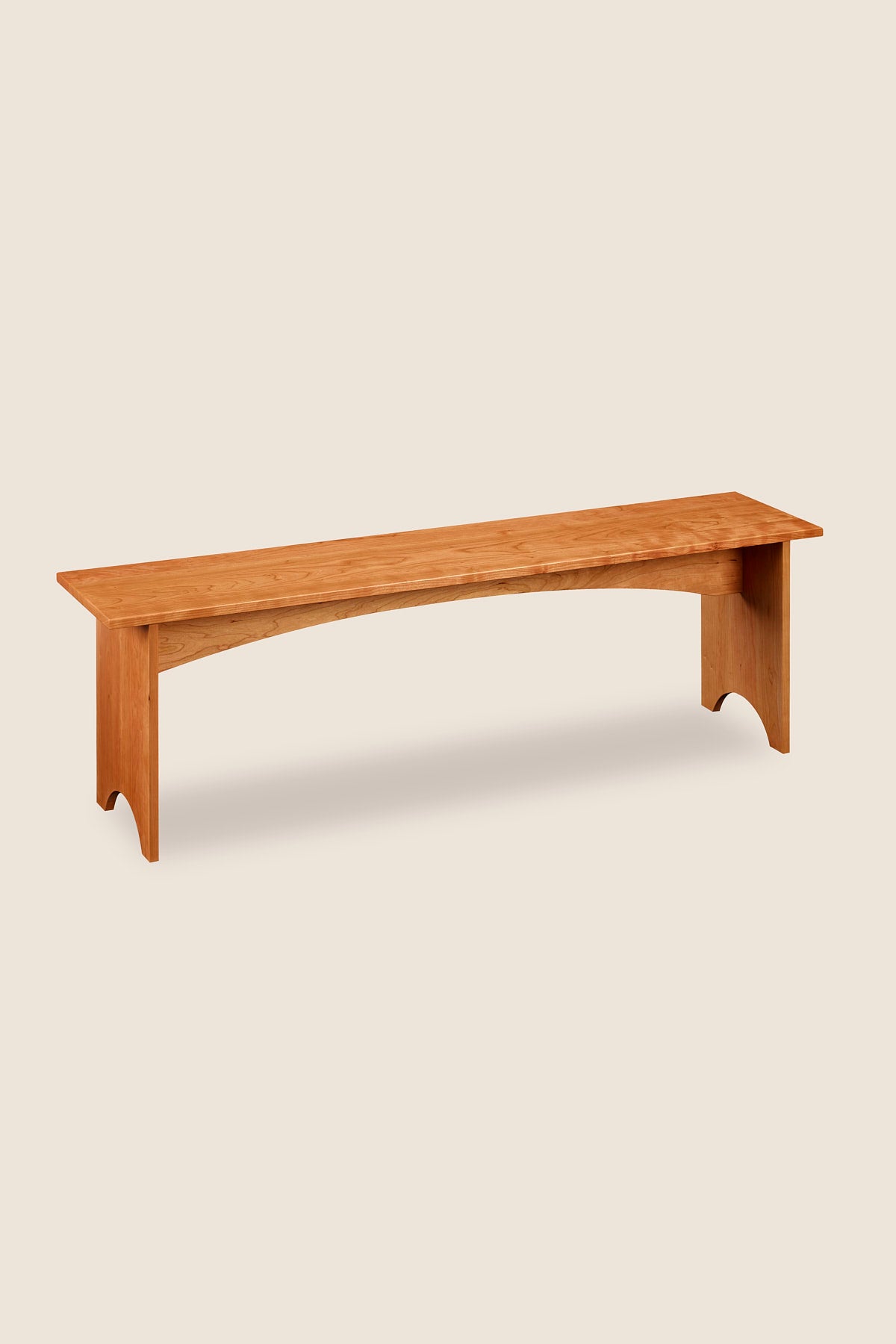 Simple five foot cherry wood bench, built in the Shaker style with arch cutout on both leg boards from Arkansas's Mazhil & Co. Co.