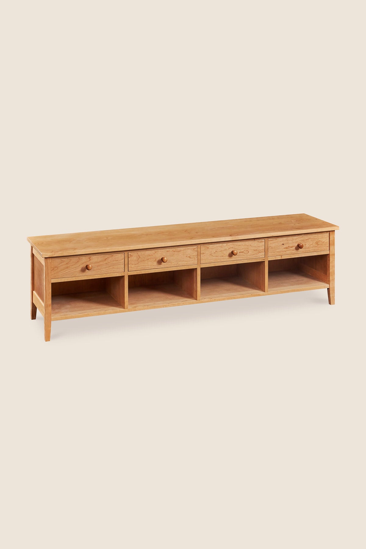Shaker style storage bench with four drawers and cubby spaces in cherry wood