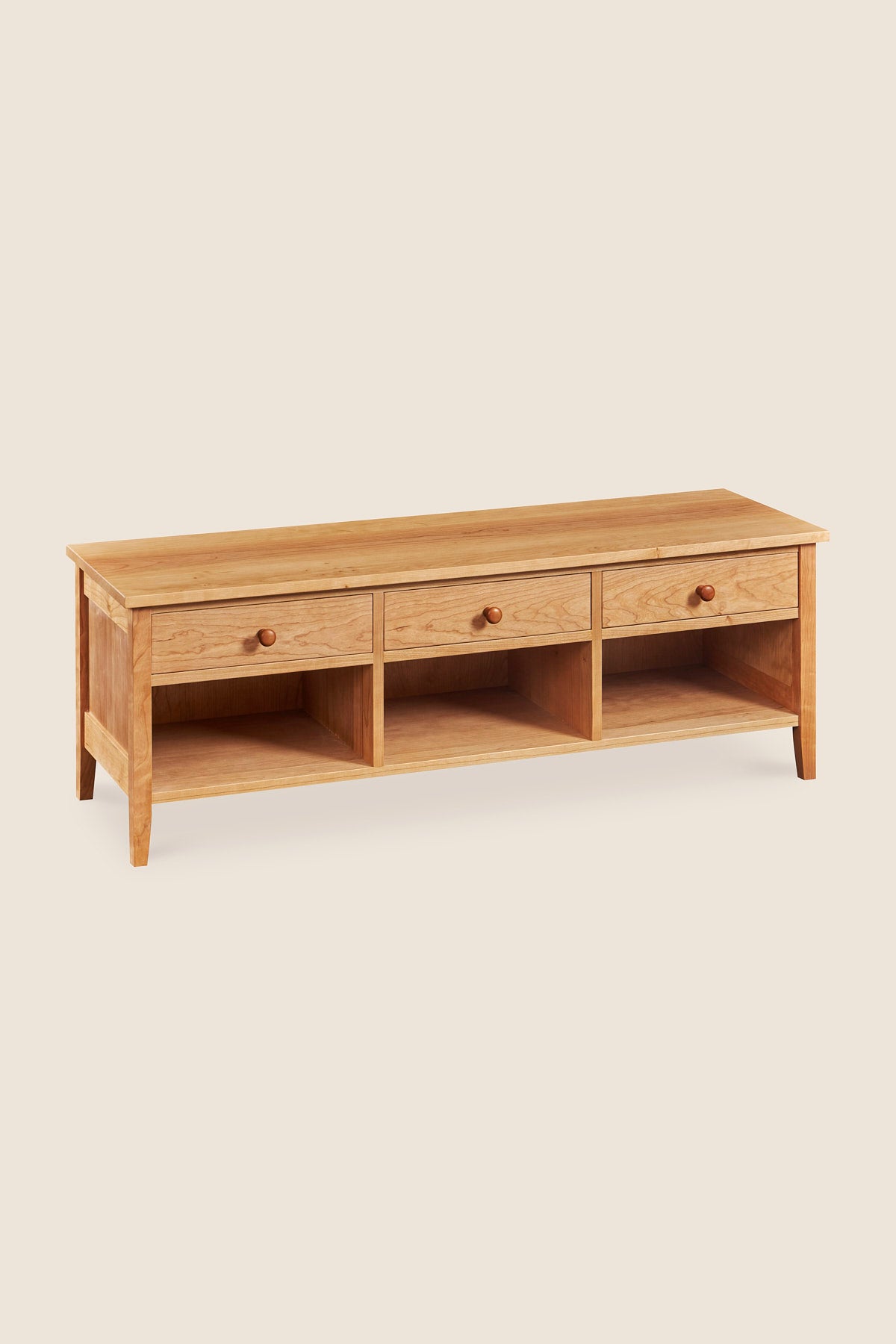 Shaker style storage bench with three drawers and cubby spaces in cherry wood