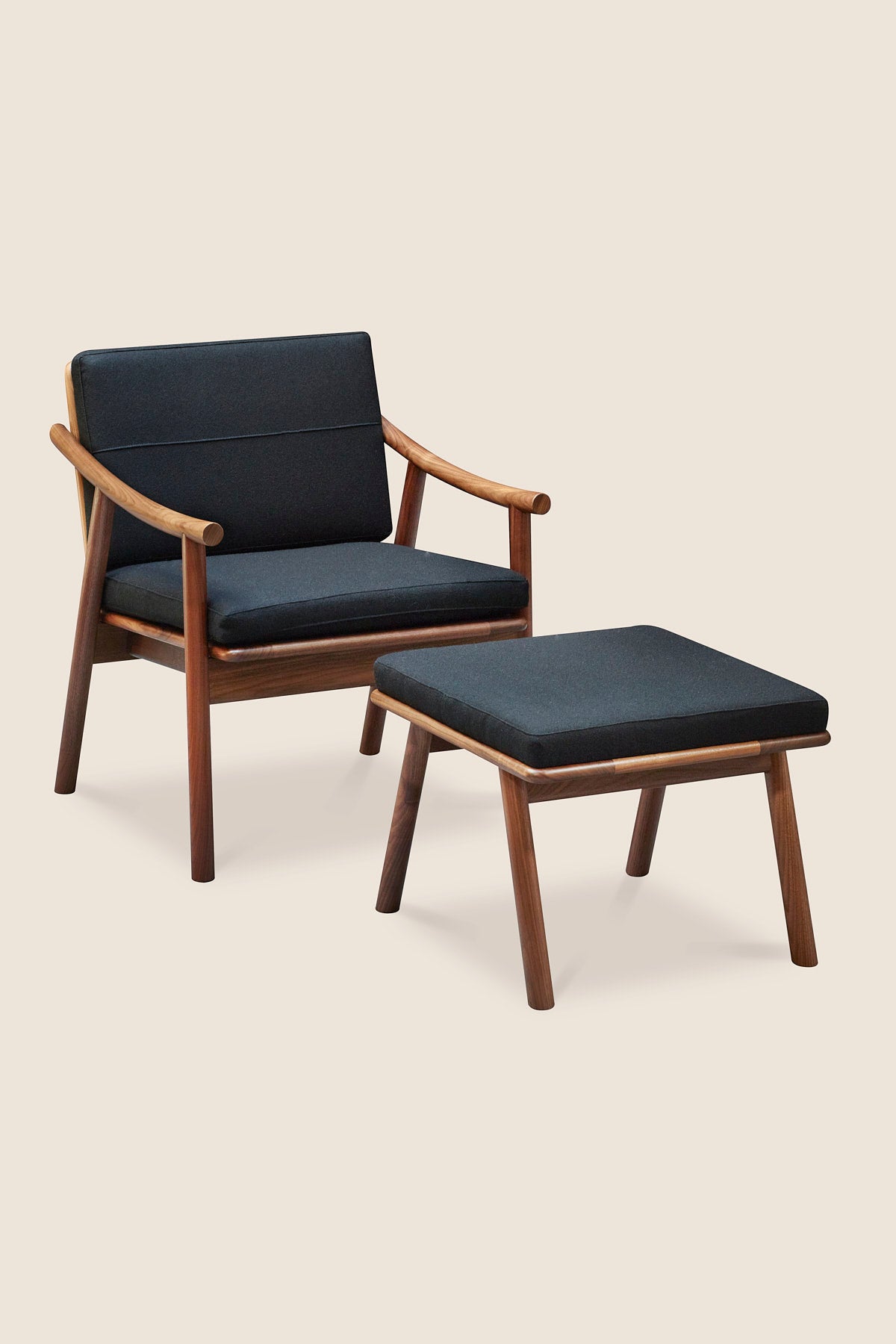 Solid walnut wood Scandinavian style Nautilus Lounge Chair and Ottoman with Knoll fabric cushions in Black, from Maine's Justines Home Co.