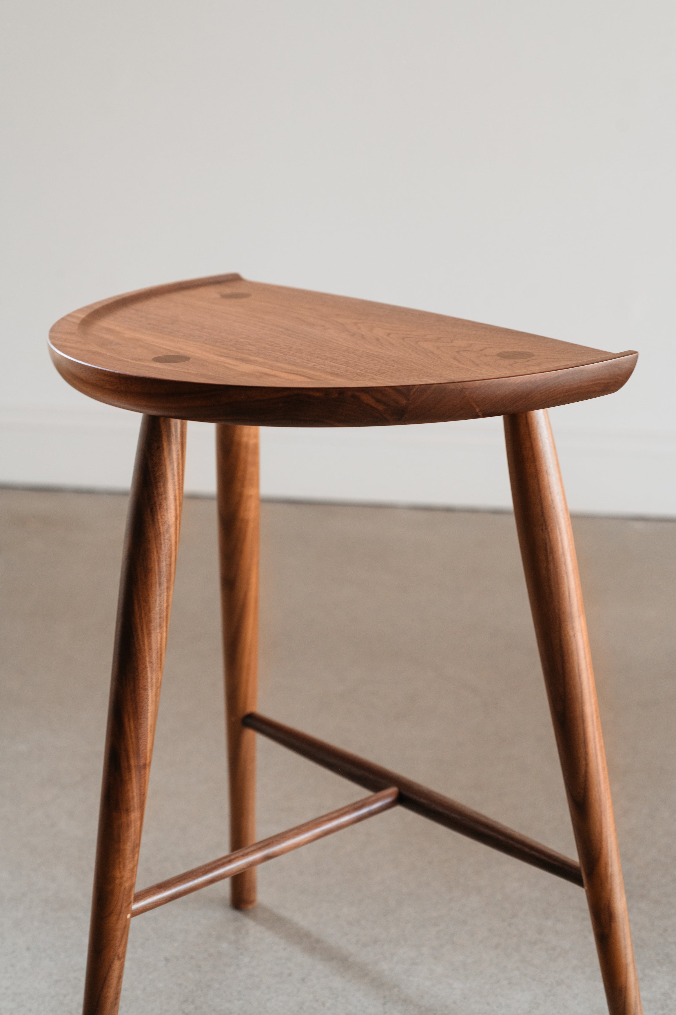 Detail of curve on back of the Shaker Stool seat from Mazhil & Co. in Arkansas