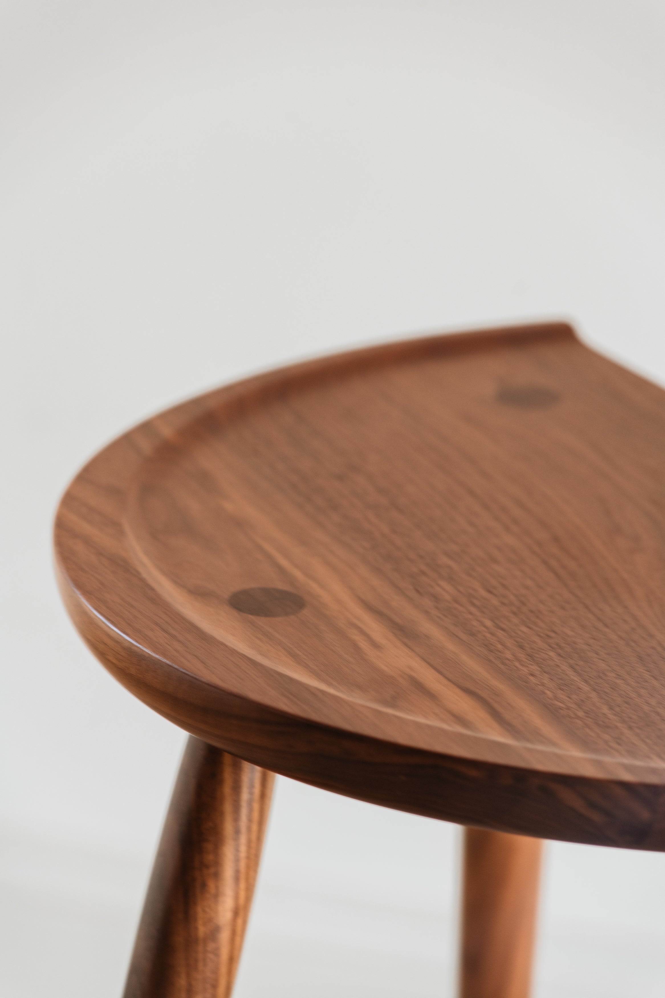 Detail of through tenon joinery and curves on seat of Shaker Stool from Mazhil & Co. in Arkansas