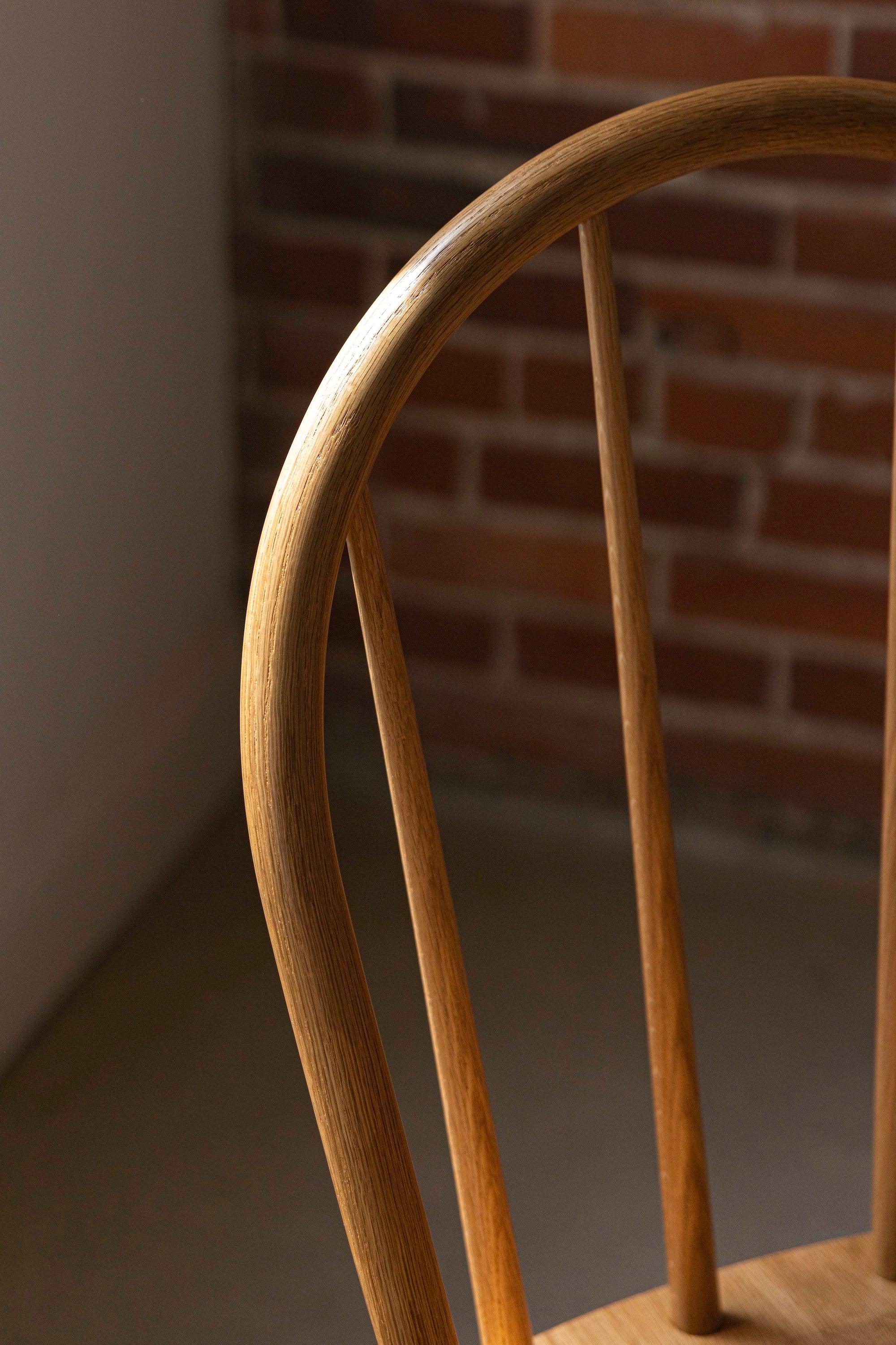 White oak grain pattern on the bowed crest of the spindle Hudson Chair