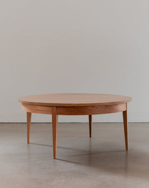 Round Shaker Heirloom Coffee Table in the showroom casting shadows