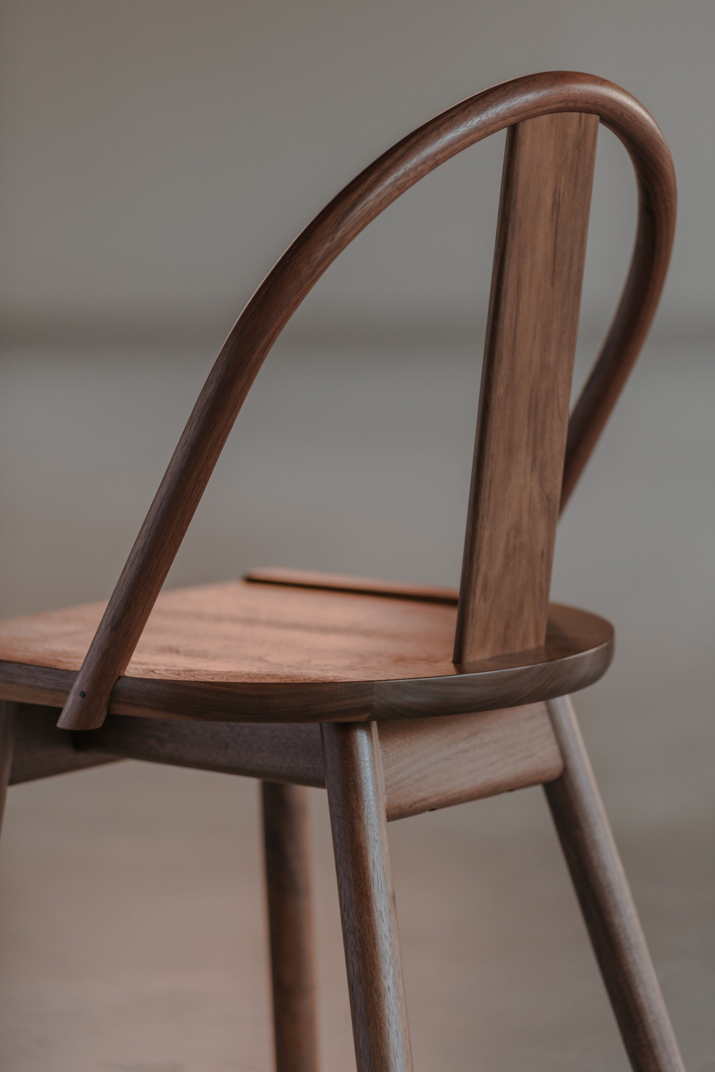 Beautiful light reflecting off the modern walnut Atlas Chair, from Mazhil & Co. in Arkansas