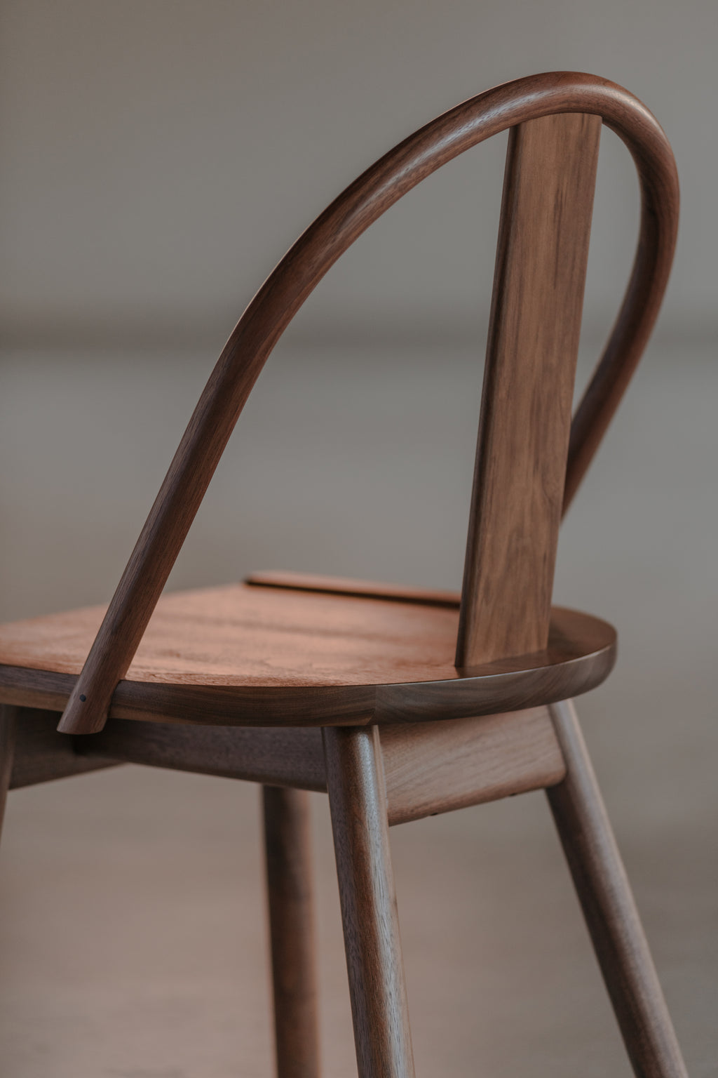 Beautiful light reflecting off the modern walnut Atlas Chair, from Chilton Furniture in Maine