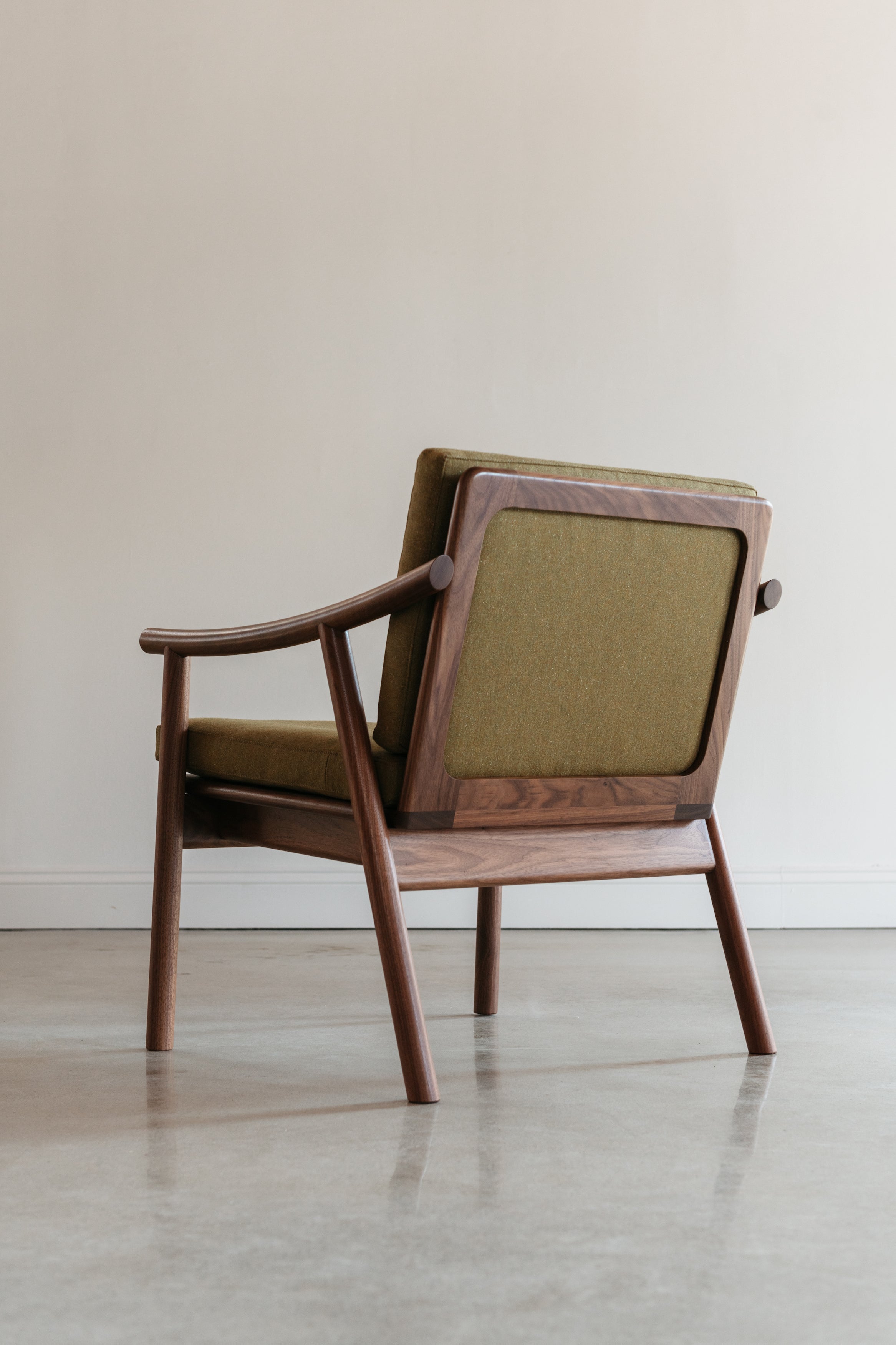 Back view of solid white oak Scandinavian style lounge chair with Knoll fabric cushions in Buff, from Maine's Chilton Furniture Co.