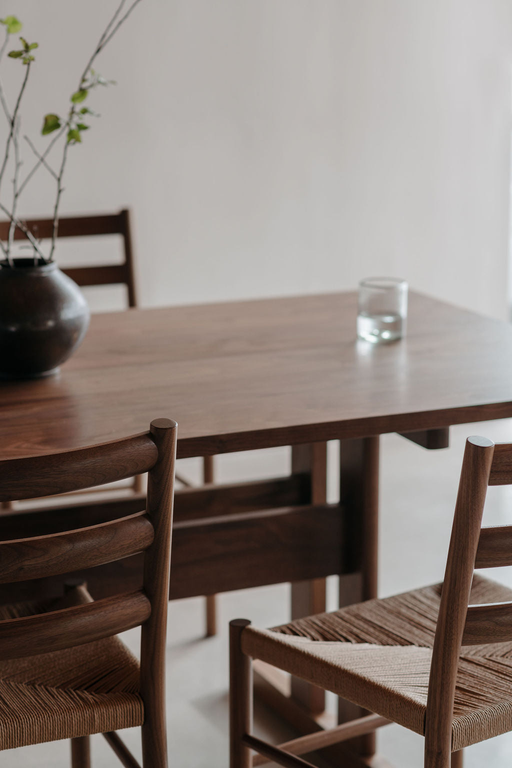 Knox ladder back chairs with Knox trestle dining table out of focus in background.